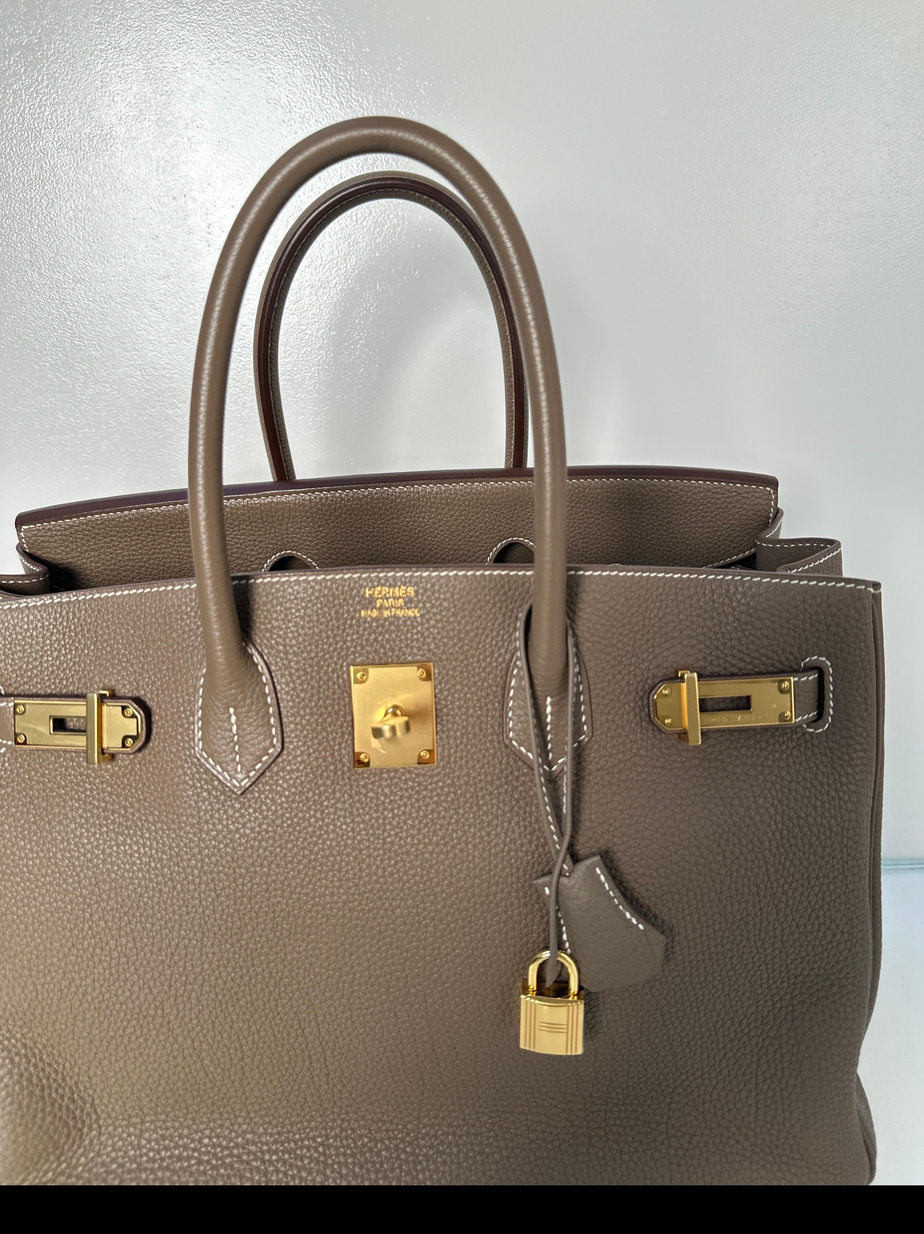 Hermes Etoupe Birkin 35 Bag. Gorgeous neutral tan grey color with gold hardware. Excellent condition. Looks like new. Plastic is still on the hardware. Includes clochette, lock, keys, and dust bag. Guaranteed authentic. Gift worthy and won't last.