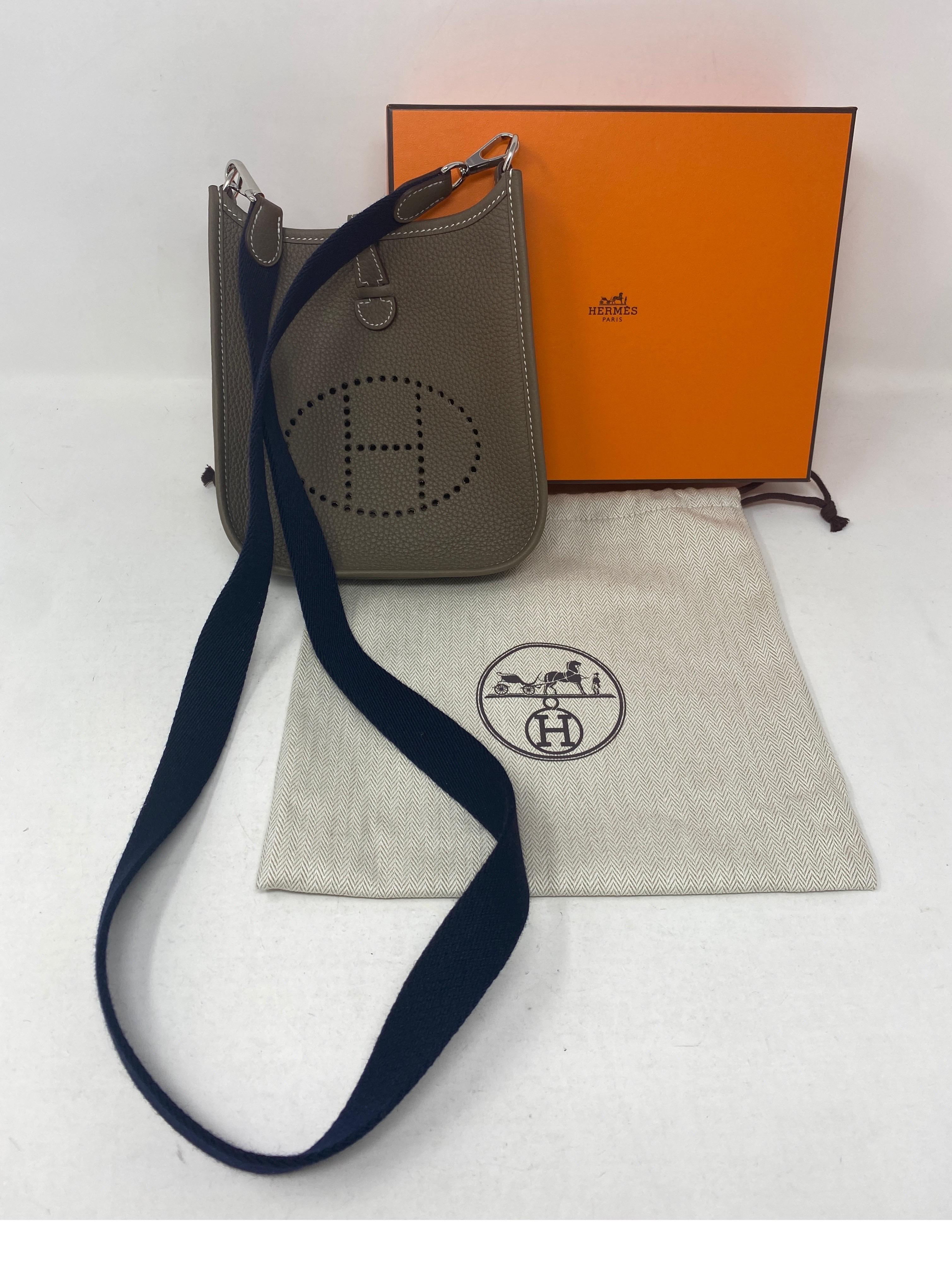 Hermes Evelyne TPM Etoupe Grey Bag. Mini evelyne bag in new condition. Palladium hardware. Hard to get mini bag. Most wanted color. Navy strap. Full set with dust bag and box. Guaranteed authentic. 