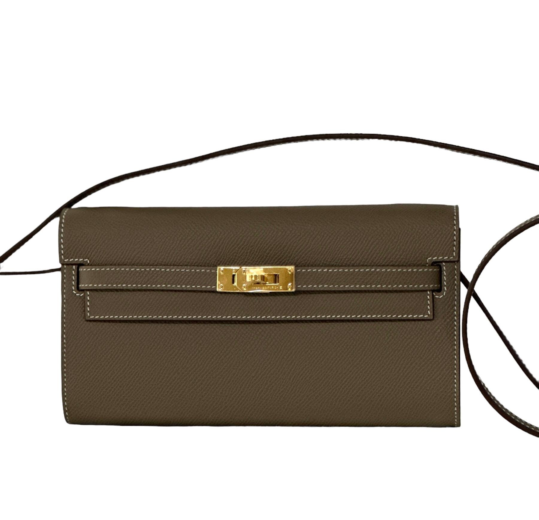 Hermes
Kelly to Go
So easy as a clutch or shoulder bag
Etoupe
Gold Hardware
Such a versatile little Bag
Constrast topstich 
Epsom Leather
Removable strap
This Kelly Wallet To Go is in Etoupe epsom leather with gold hardware and has contrast