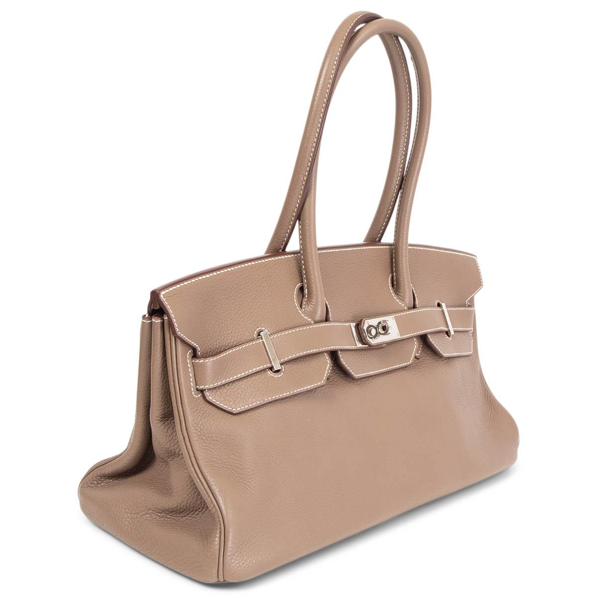 100% authentic Hermès 'JPG I Shoulder Birkin' bag in Etoupe (taupe) Clemence leather with contrasting white stitching and palladium hardware. Lined in Chevre (goat skin) with two open pockets against the front and a zipper pocket against the back.