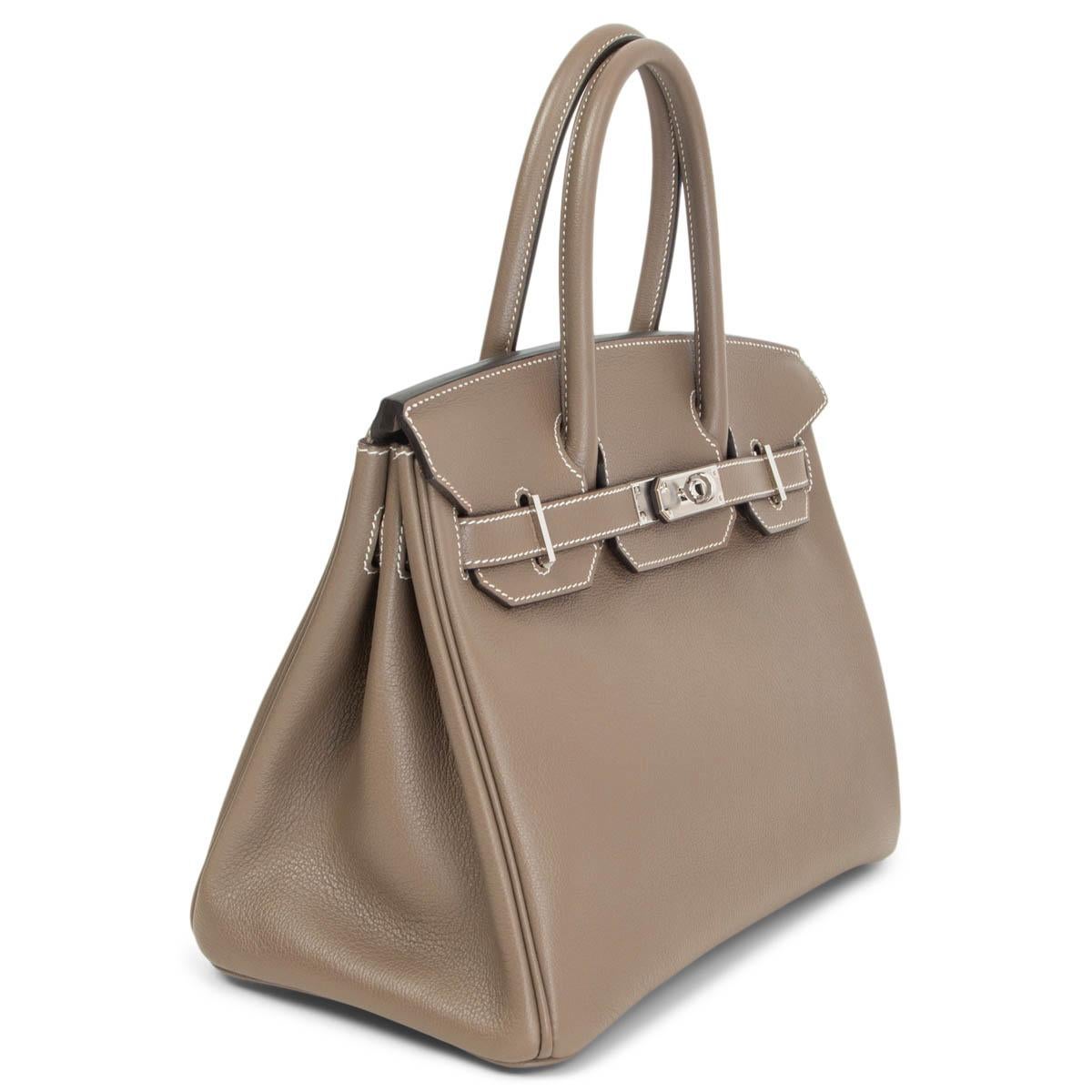 100% authentic Hermès Birkin 30 bag in Etoupe (taupe) Taurillon Novillo leather with contrasting white stitching and Palladium hardware. Lined in Chevre (goat skin) with an open pocket against the front and a zipper pocket against the back. Has been