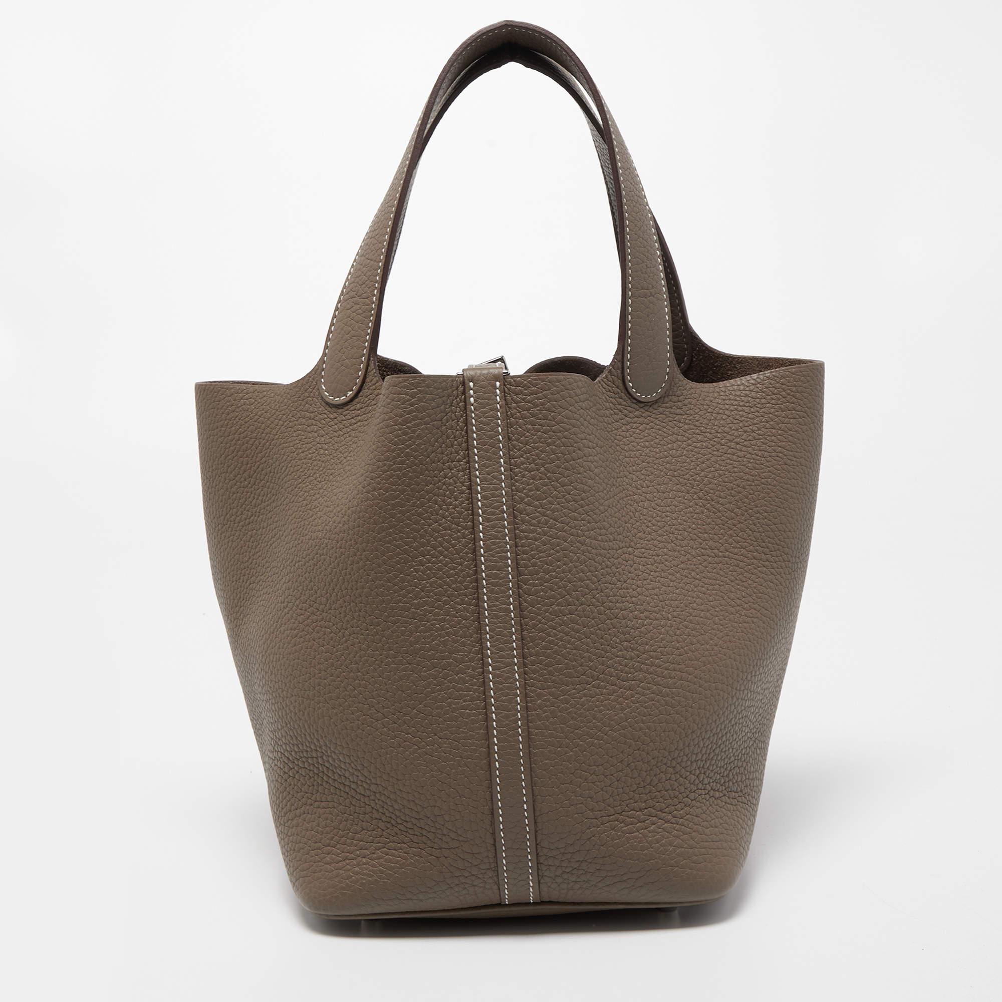 Wonderfully crafted from leather, this Picotin from Hermes is a creation for people who love a perfect blend of luxury and style. It comes in a classy hue, and it sits in a relaxed shape with two handles and a spacious interior. Armed with