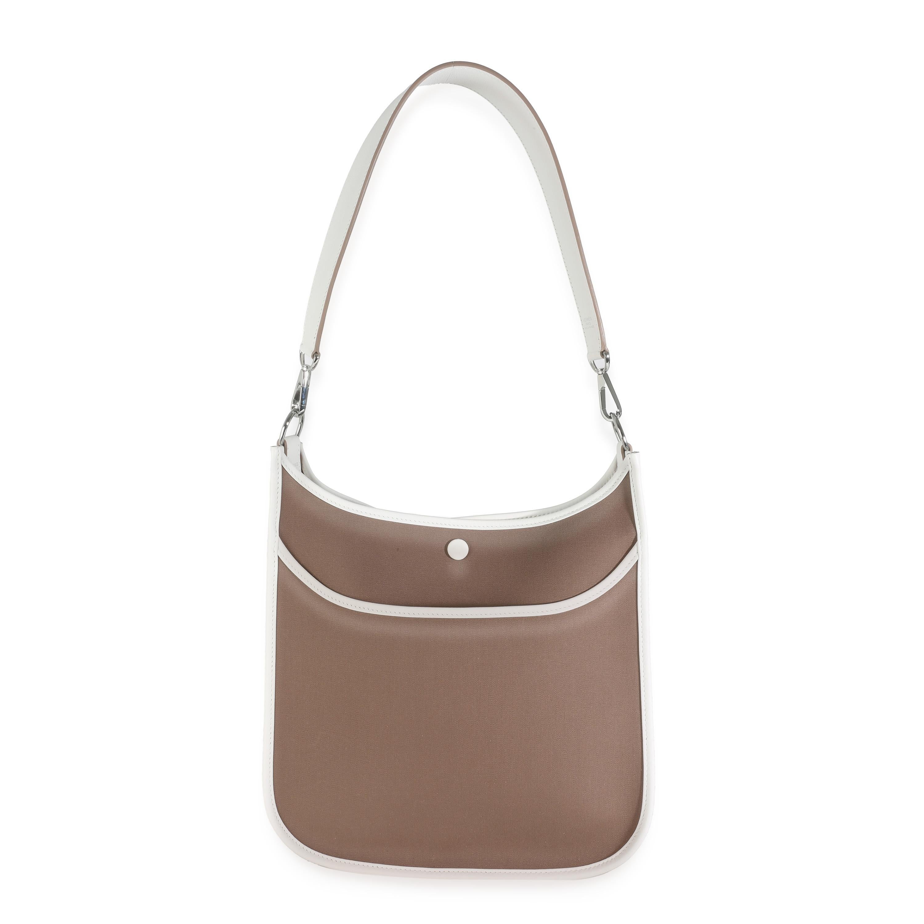 Listing Title: Hermès Etoupe Toile Officier Swift Neo Evelyne 29 PHW
SKU: 142519
Condition: Pre-owned 
Condition Description: Designed in 1978 by Evelyne Bertrand, the Evelyne shoulder bag from Hermès has a distinctive aesthetic thanks to a