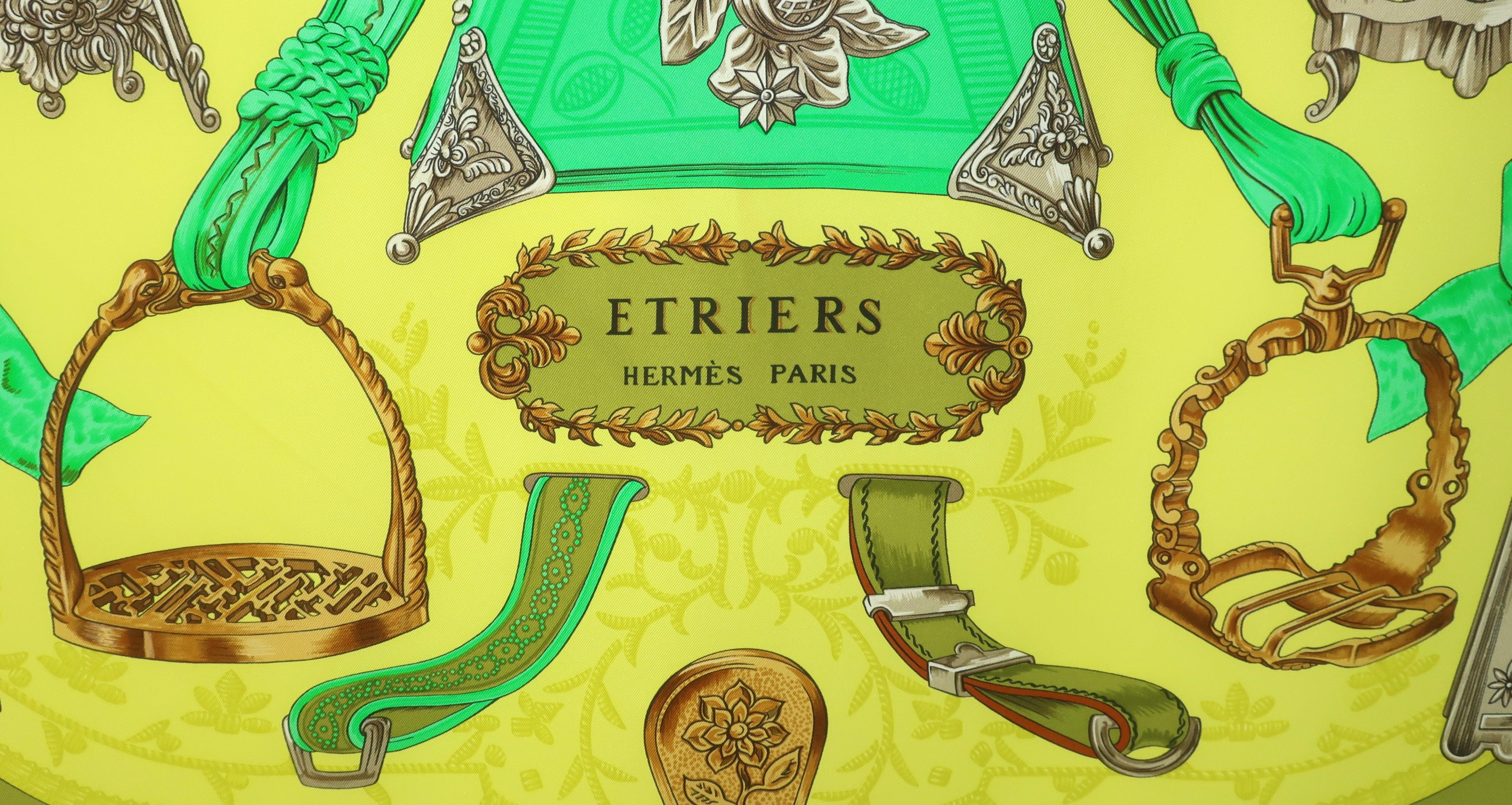 Long ago, Hermes perfected the artistic beauty of the silk scarf.  The 'Etriers' stirrup themed silk scarf was originally issued by artist Francoise de la Perriere in 1964.  This version in vibrant shades of green, chartreuse, olive, gray and camel