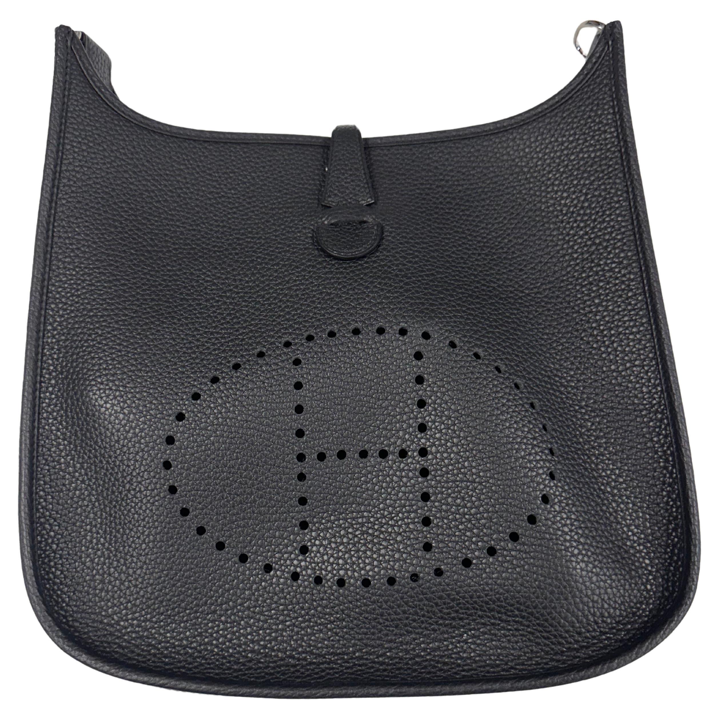 Supple leather, quiet luxury Evelyn bag is an understated Hermes classic.

Color: Black
Material: Leather
Measures: Height 11” x Length 21” x Depth 2”
Drop: 20” (strap)
Comes with: Dust bag
Condition: Very good. Faint marks throughout.

Made in