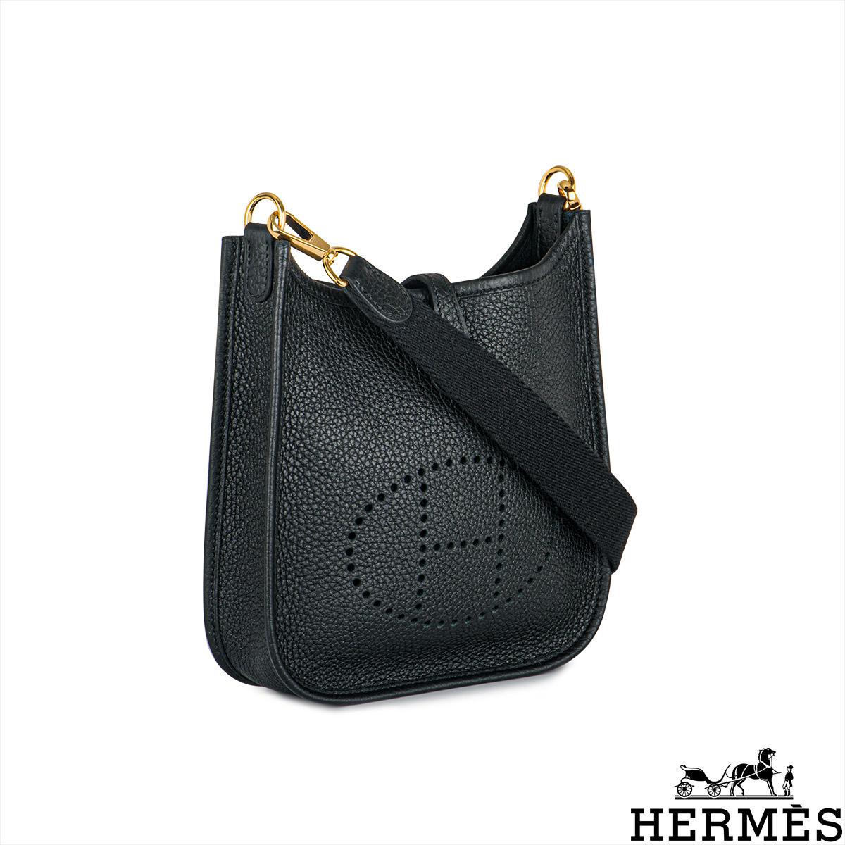 A lovely Hermès mini Evelyne handbag. The exterior of this Evelyne bag is crafted from black Taurillon Clemence leather complemented with gold tone hardware and tonal stitching. It features a perforated 