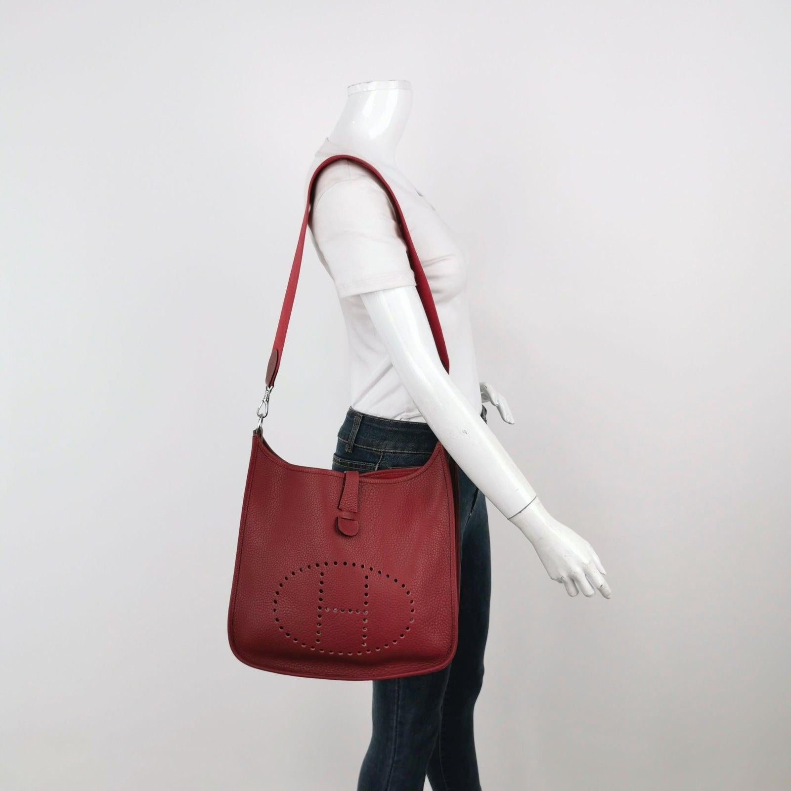 Hermes Evelyne 33 Large Crossbody Bag Burgundy with Strap These are professional photos of the actual bag offered by Luxbags. The Hermes Evelyne 33 Large Crossbody Bag offers a minimalist silhouette and lightweight design, providing freedom for both