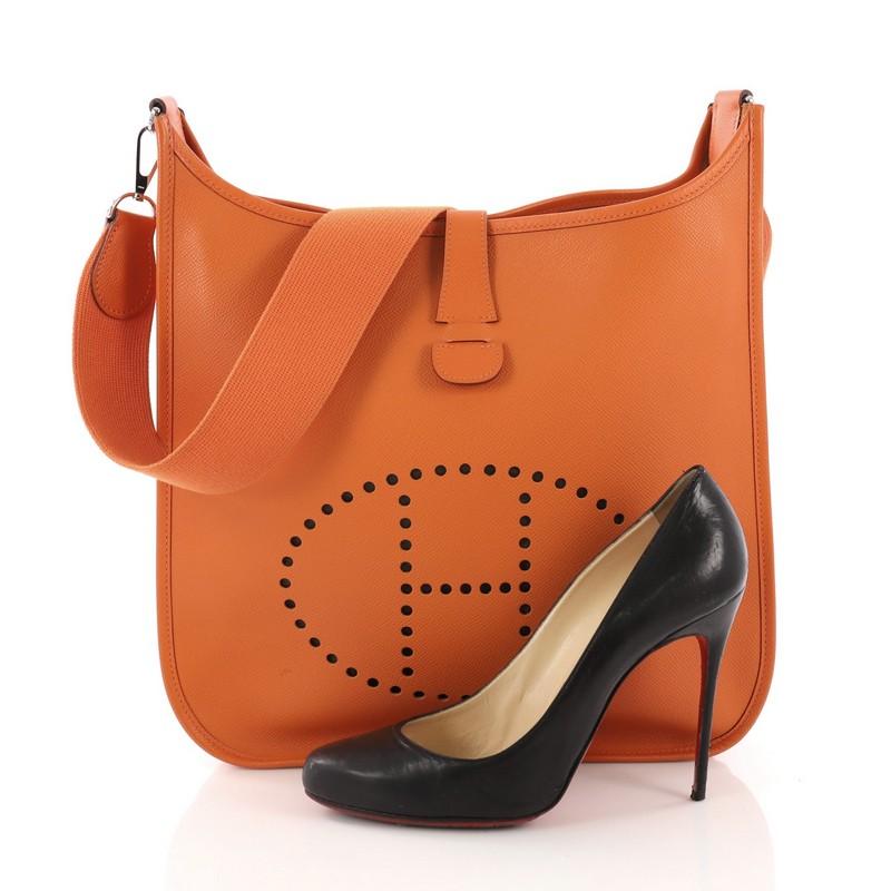This Hermes Evelyne II GM, crafted in Orange H Epsom leather, features the signature perforated H design at the front, long crossbody strap, and palladium hardware. It opens to an Orange H raw leather interior. Date stamp reads: K Square (2007).