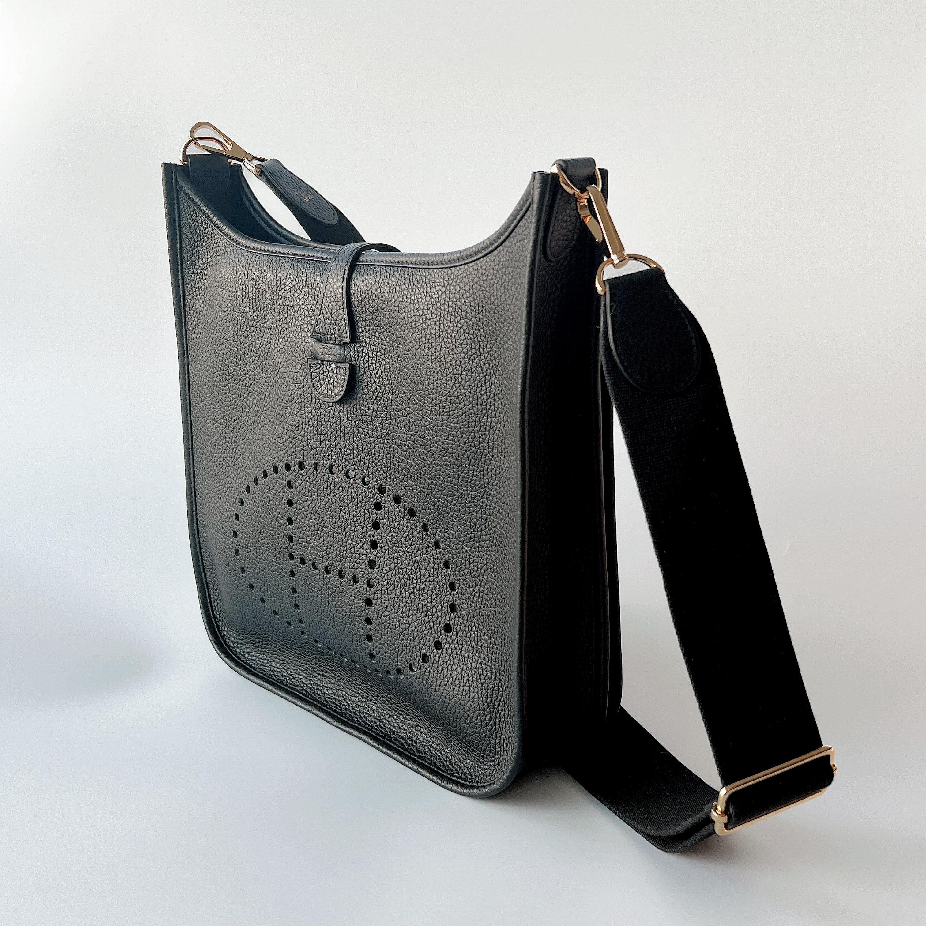 Hermes Evelyne III 29 Bag In Black with classic Gold Hardware. The Evelyne comes in clemence leather with an adjustable strap. The detailing is a perforated 