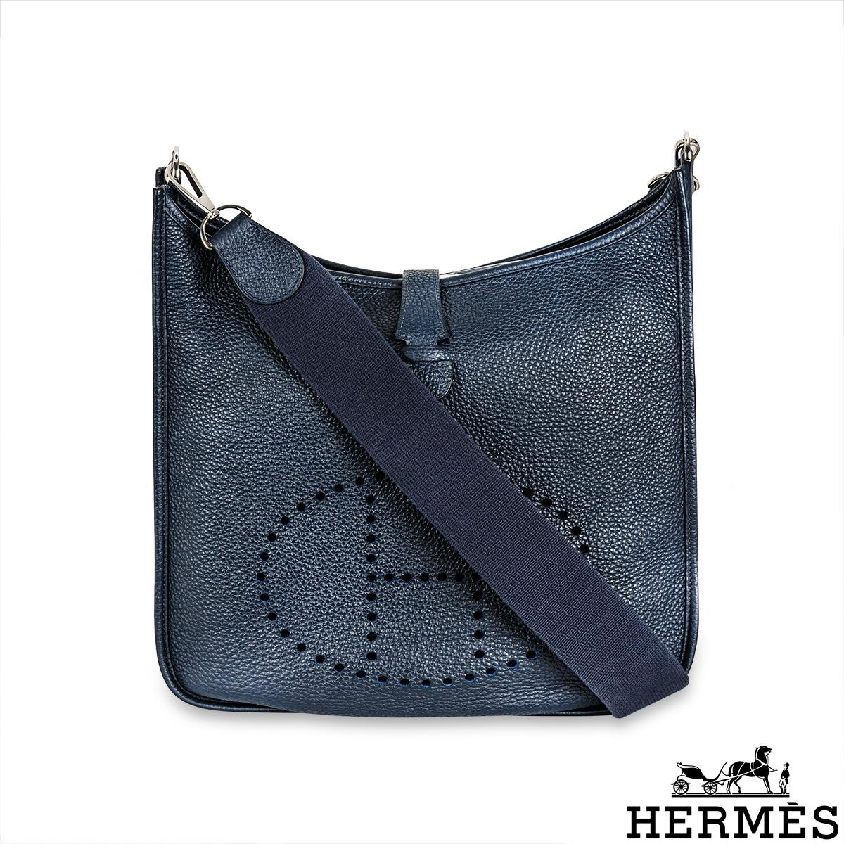 A lovely Hermès Evelyne GM handbag. The exterior of this Evelyne bag is crafted from Bleu Nuit Taurillon Clemence leather complemented with palladium hardware and tonal stitching. It features a perforated 