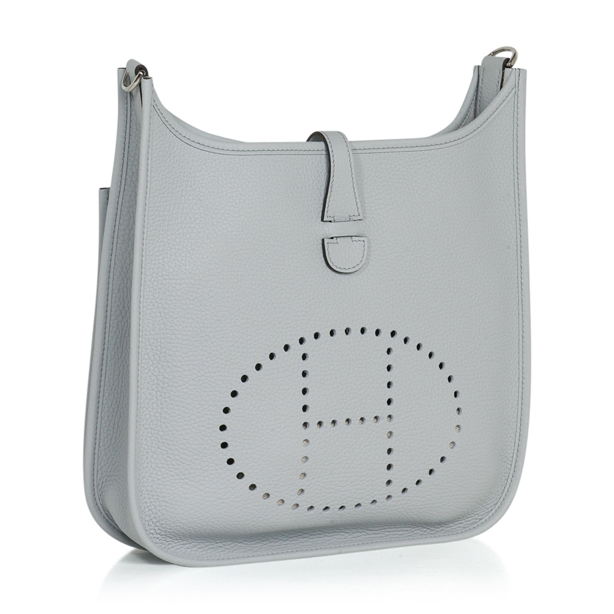 Guaranteed authentic Hermes Evelyne PM featured in beautiful Blue Pale. 
Fresh with palladium hardware.
Plush clemence leather. 
Fabulous shoulder or cross body bag with roomy interior and rear outside deep pocket. 
Sport strap in textile with