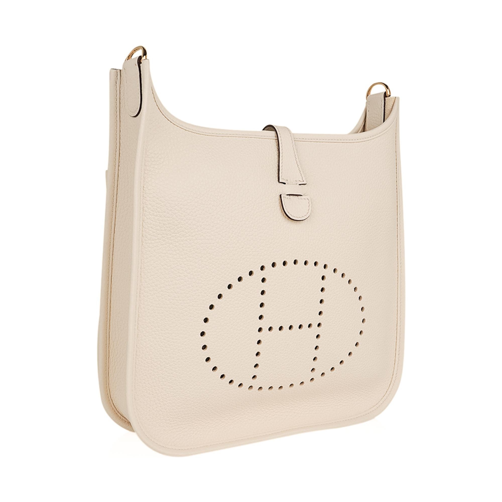Mightychic offers an Hermes Evelyne PM featured in neutral coveted Nata. 
Rich with gold hardware.
Plush Clemence leather.
Fabulous shoulder or cross body bag with roomy interior and rear outside deep pocket.
Sport strap in textile with leather and