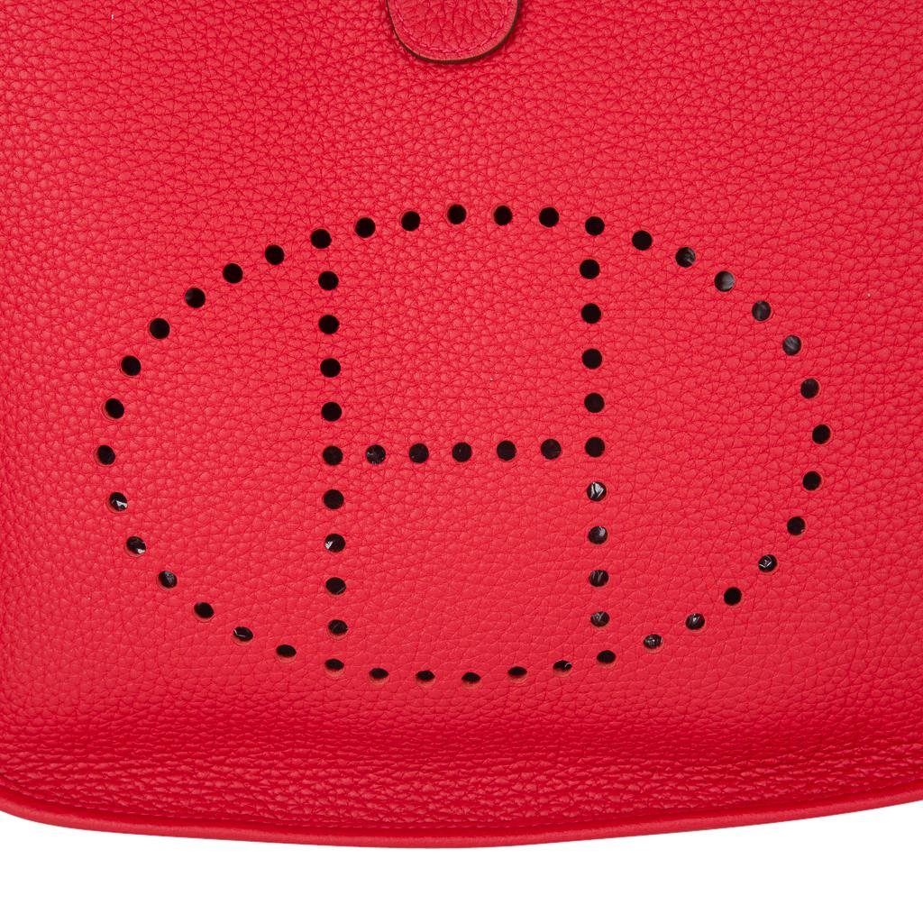 Guaranteed authentic Hermes Evelyne PM featured in vivid Rouge Casaque.
Rich with palladium hardware.
Plush clemence leather.
Fabulous shoulder or cross body bag with roomy interior and rear outside deep pocket. 
Sport strap in textile with leather