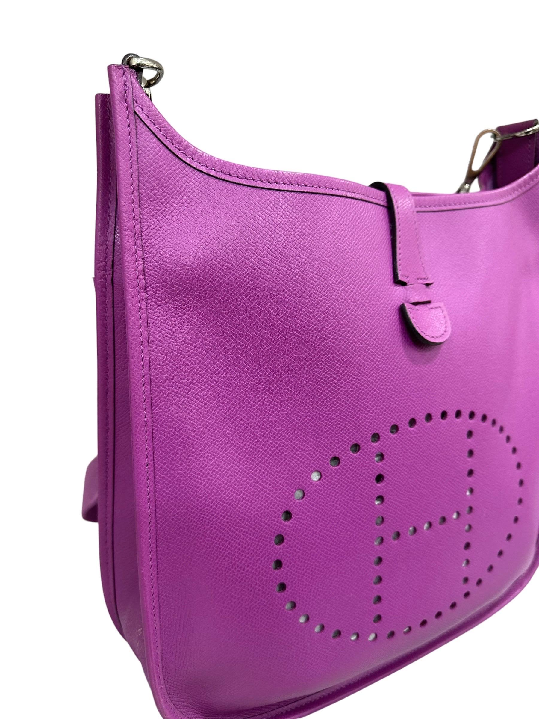 Bag signed Hermès, model Evelyne, size PM, made in anemone epsom leather with silver hardware. Equipped with a central band with interlocking button closure, internally lined in purple suede, quite large. Equipped with a removable shoulder strap for