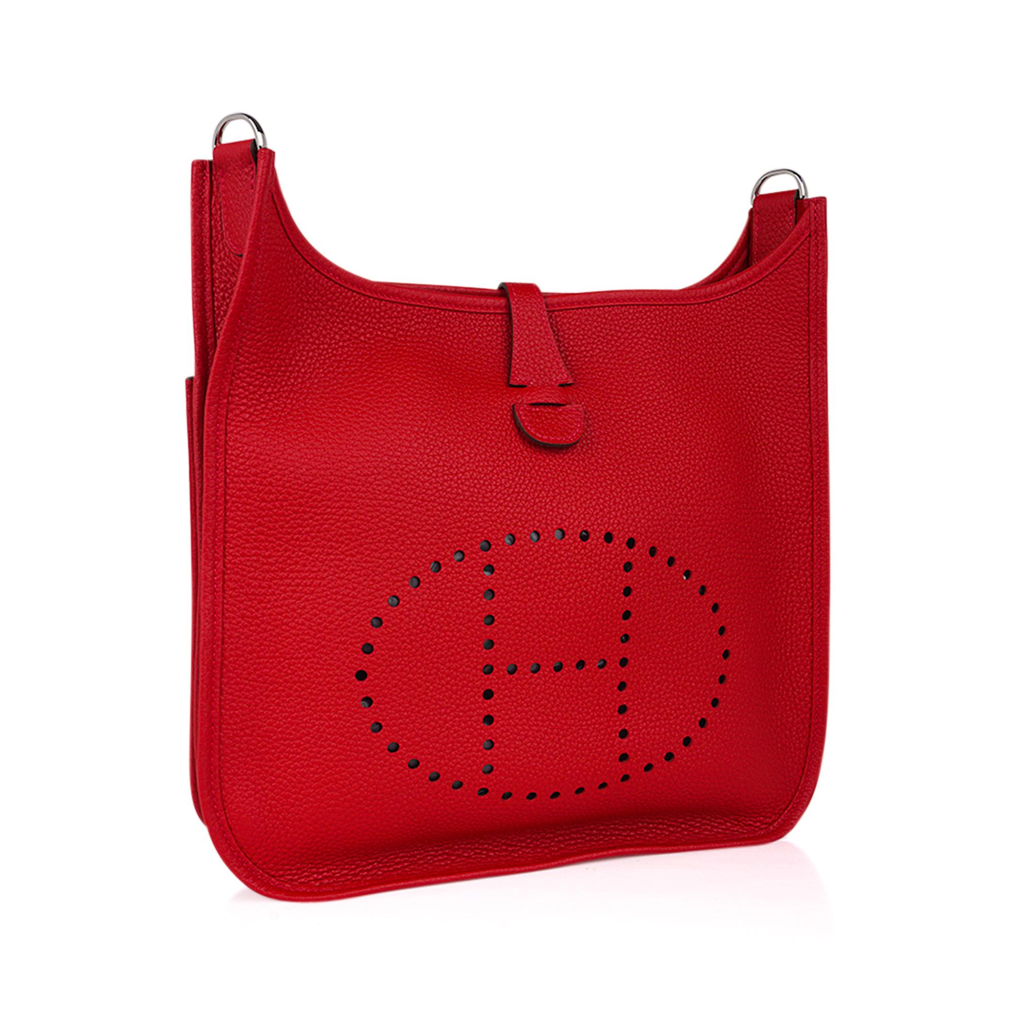 Mightychic offers an Hermes Evelyne PM featured in vivid Rouge Casaque.
Rich with palladium hardware.
Plush clemence leather.
Fabulous shoulder or cross body bag with roomy interior and rear outside deep pocket. 
Sport strap in textile with leather