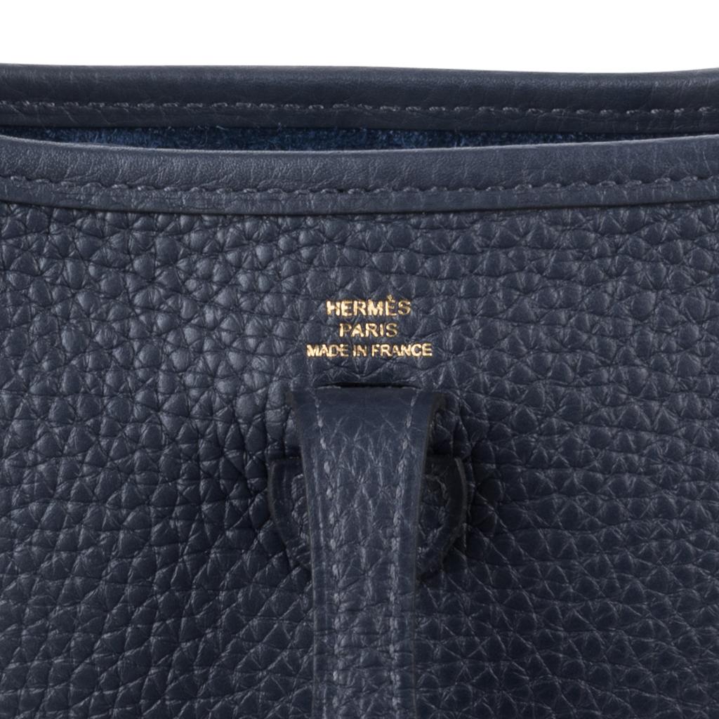 Guaranteed authentic rich Blue Nuit  Hermes Amazone Evelyne TPM bag.  
Clemence leather which is soft and scratch resistant. 
Sport canvas body strap is crisp and clean with gold hardware.
Signature perforated H on front of bag.
Fabulous shoulder or