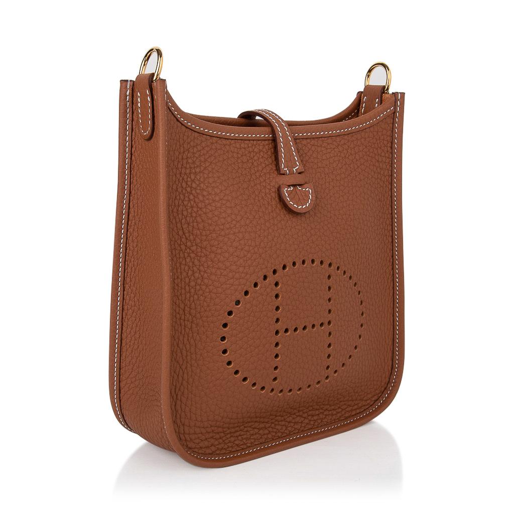 Mightychic offers an Hermes Evelyne TPM bag featured in iconic Gold.  
Clemence leather is soft and scratch resistant.
Signature perforated H on front of bag.
Rare with gold hardware.
Fabulous shoulder or cross body bag. 
Sport strap in textile with