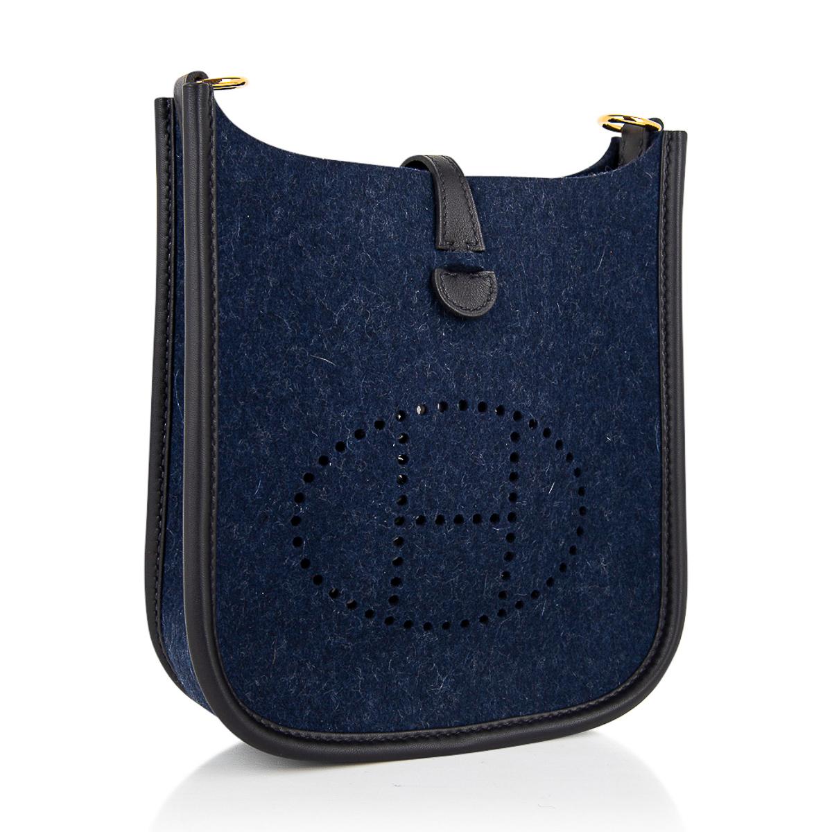 Mightychic offers an Hermes Evelyne TPM featured in Blue Feutre (felt) with Gold hardware.  
Trimmed in Black Swift leather.
Signature perforated H on front of bag.
Fabulous shoulder or cross body bag. 
Black Sport strap in textile with leather and