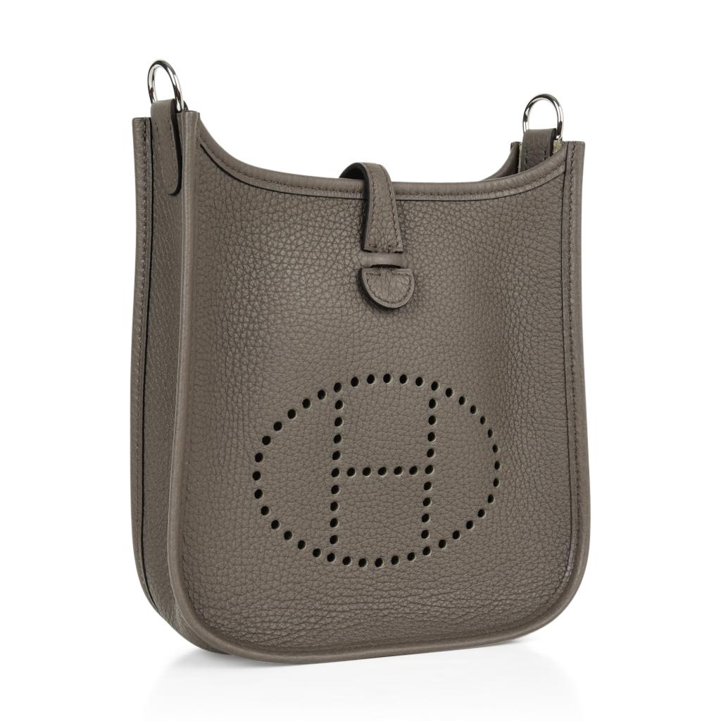 Guaranteed authentic Hermes Evelyne TPM Mini in Clemence and neutral Etain. 
Clemence leather is soft and scratch resistant.
Signature perforated H on front of bag.
Fresh with Palladium hardware.
Fabulous shoulder or cross body bag. 
Sport strap in