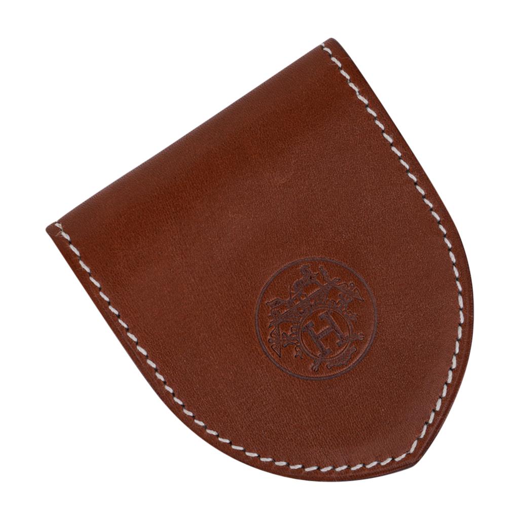Mightychic offers a guaranteed authentic Hermes Ex-Libris bookmark featured in Barenia leather.
White top stitch frames the unmistakable Hermes logo stamped on both sides.
Hidden magnets for closure.
Comes with brown embossed Hermes pouch and