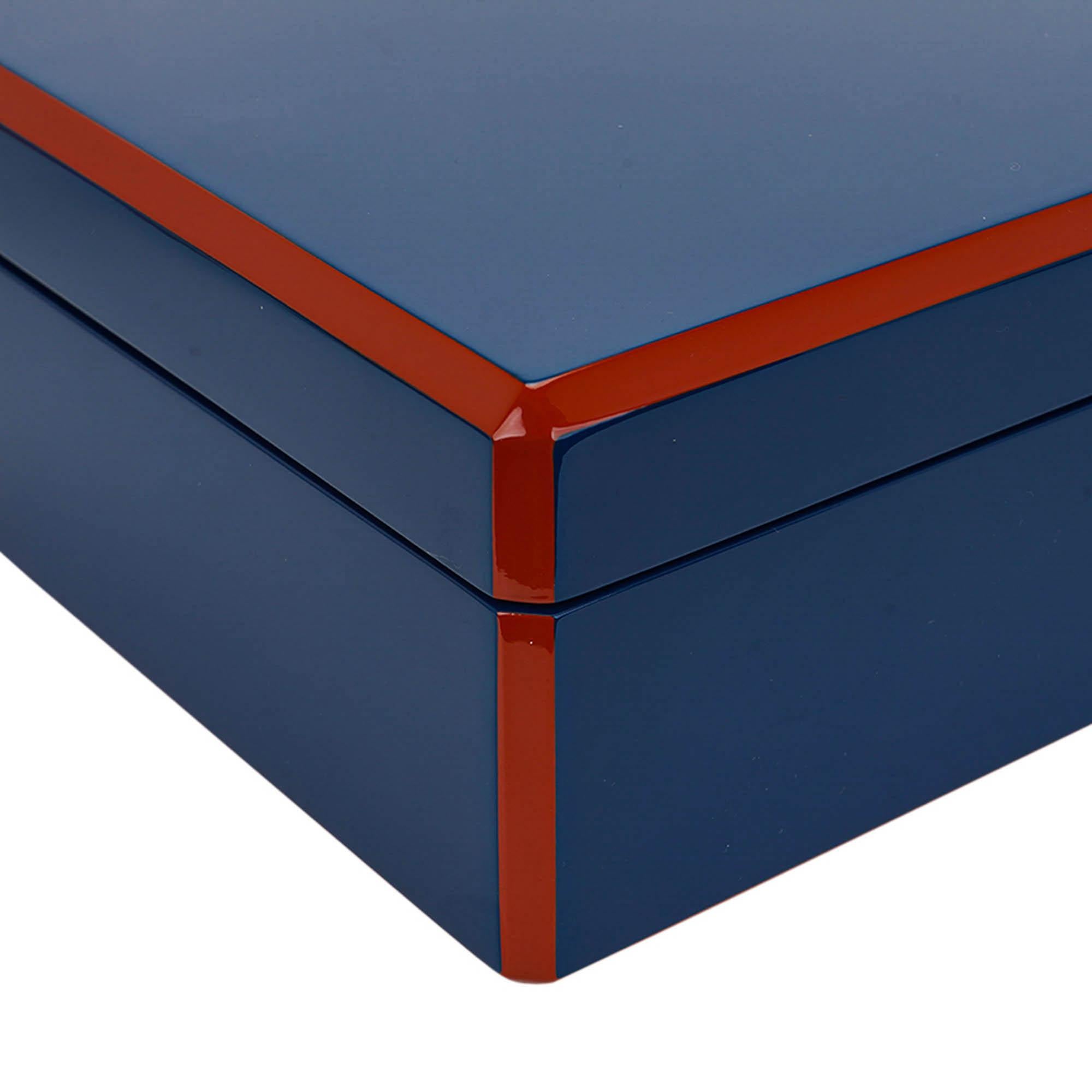 Mightychic offers an Hermes Facettes Tie Box featured in Biarritz Bleu and Terrecotta.
Beautifully showcased in shiny hand lacquered wood logo engraved.
Interior is in a matte lacquer and has a removable divider to organize up to 8 ties.
Made in