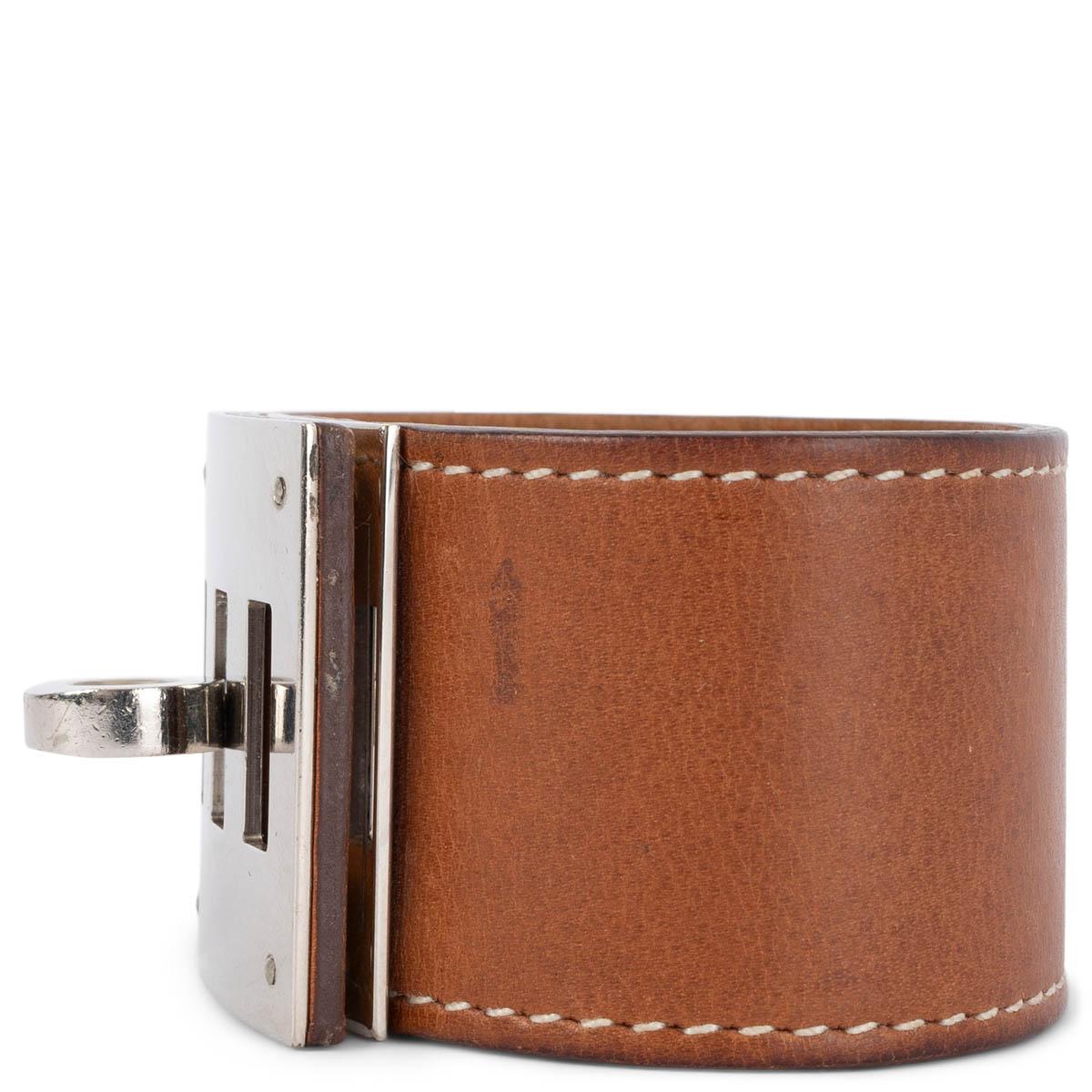 100% authentic Hermès Kelly Dog cuff bracelet in Fauve (cognac) Veau Barenia leather featuring contrasting white stitching and Palladium hardware. Has been worn and shows overall a natural patina to the leather and fine scratches to the
