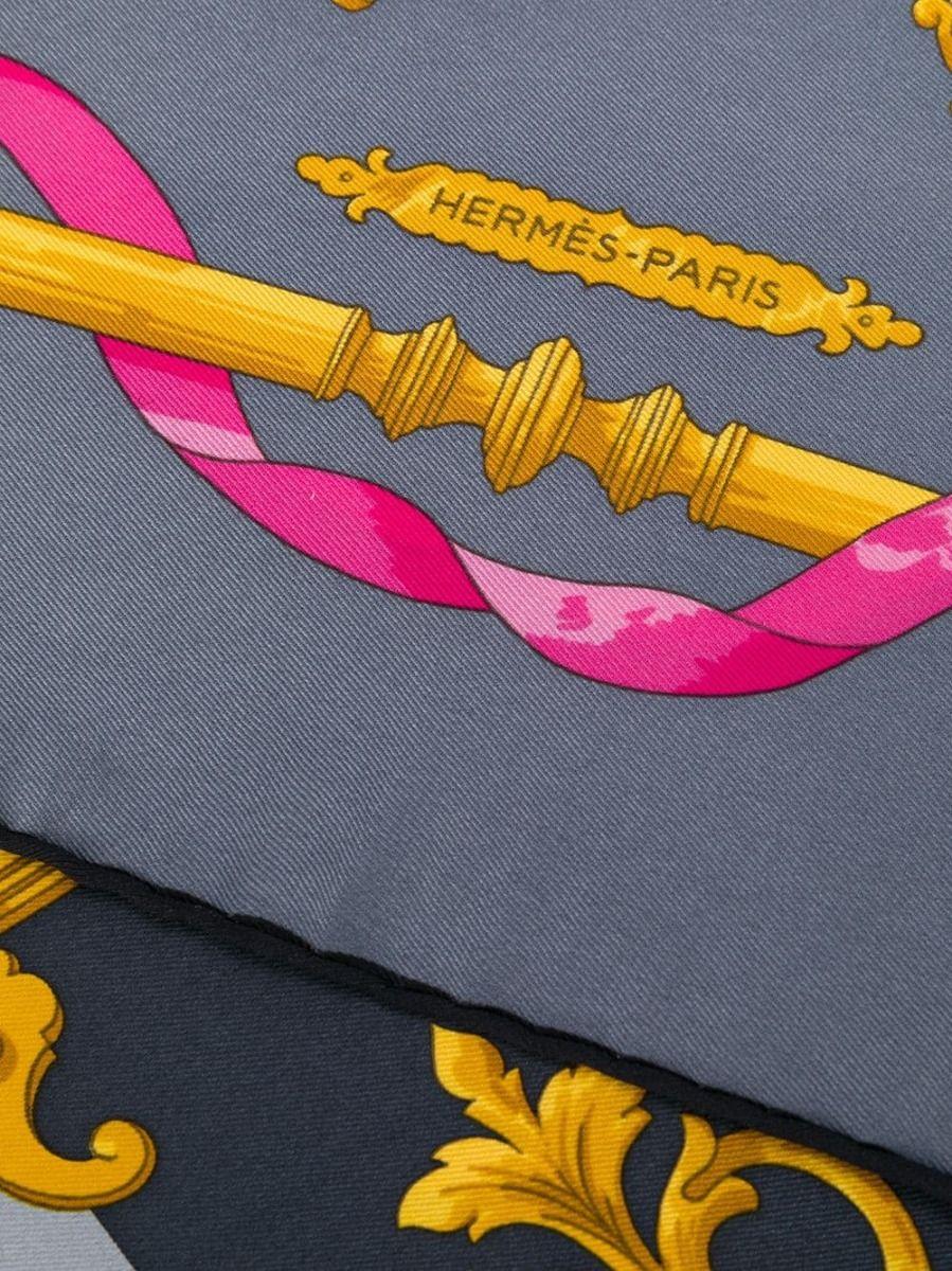 Crafted in France from 100% silk, featuring a light grey, charcoal, and pink Feronnerie print with hand-rolled edges, this Hermès scarf is a true effortless statement piece.

Colour: Light Grey, Charcoal, Pink

Composition: 100% silk

Measurements: