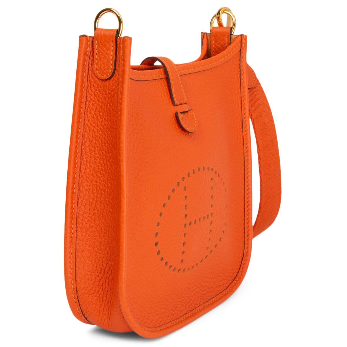 100% authentic Hermès Evelyne 16 Amazone crossbody bag in Feu (orange) Taurillon Clemence leather with sangle wool strap in Feu, perforated leather 