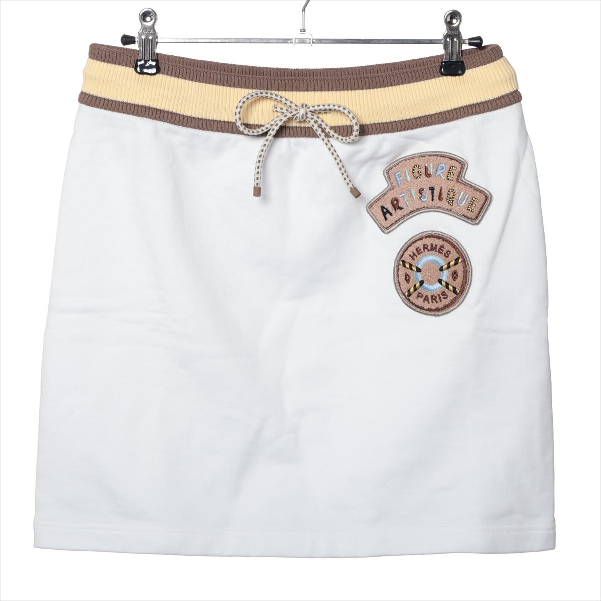 The Hermès Skirt in White is a stylish and versatile piece that combines elegance with unique detailing. It features an adjustable waistband, ensuring a comfortable and tailored fit. The skirt is adorned with striking brown and yellow stripes,