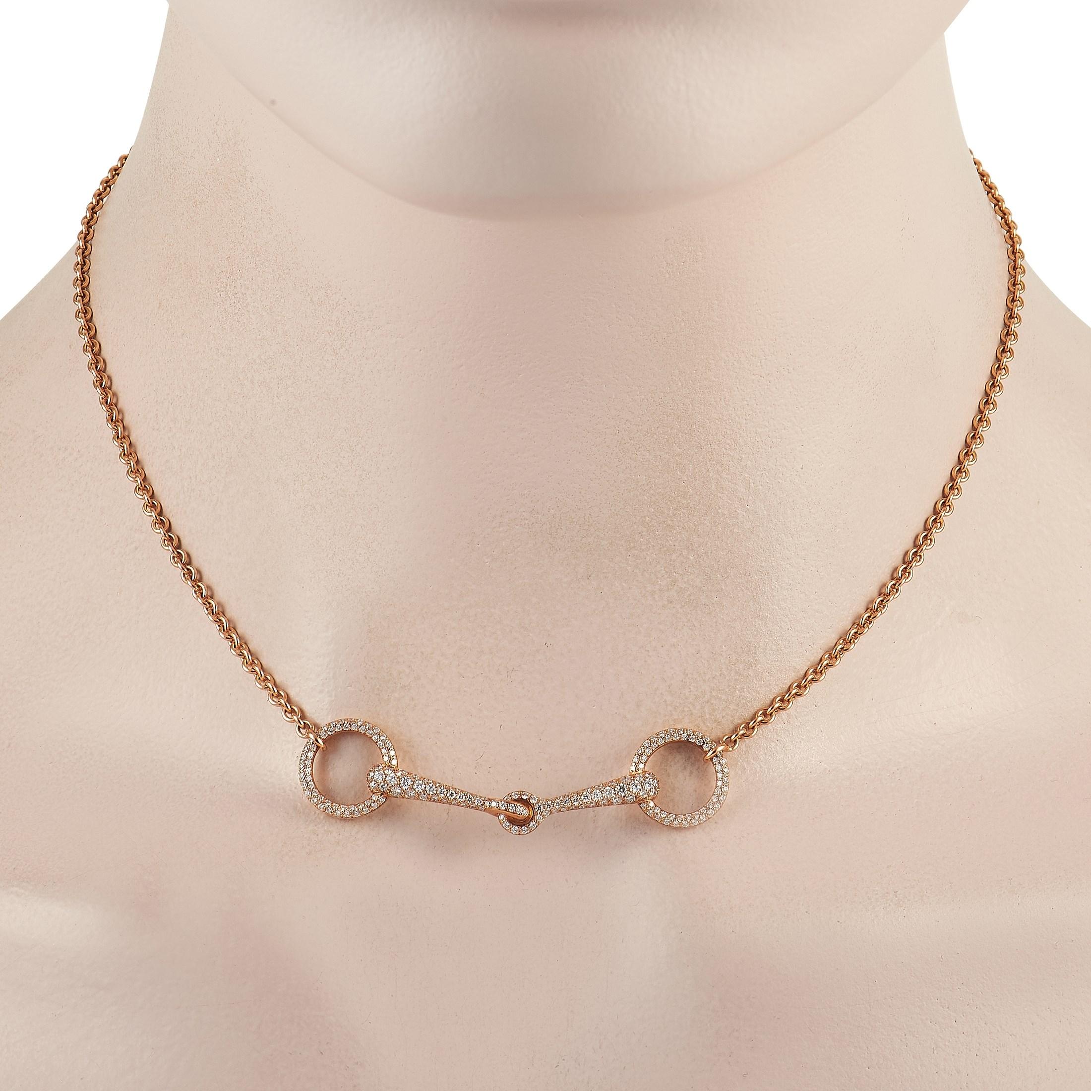 This Hermes Filet D’Or necklace pays tribute to the beauty of equestrian buckles. Crafted from 18K Rose Gold, the delicate pendant measures 2” long, 0.5” wide, and is covered in sparkling diamonds totaling 0.96 carats. It sits at the center of a