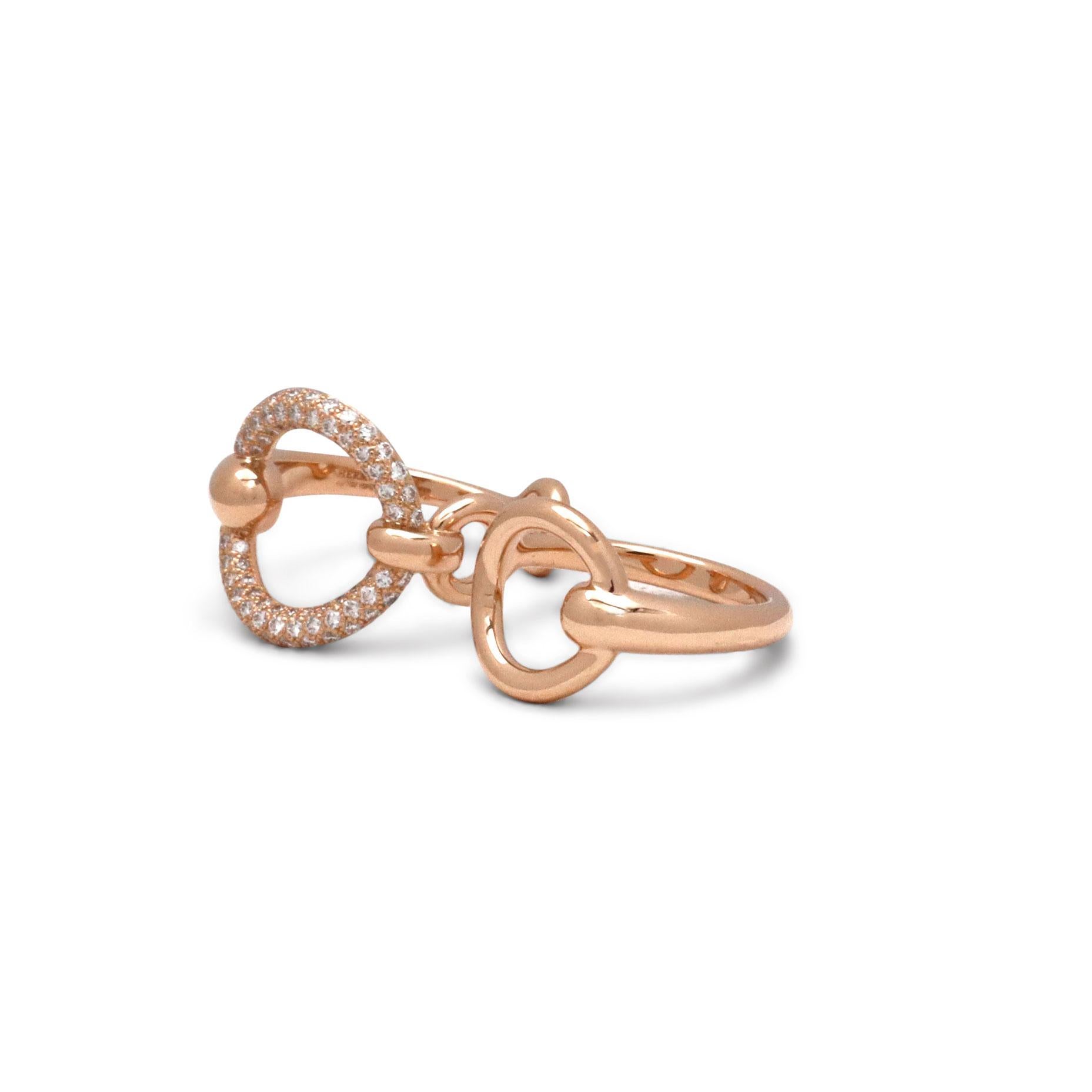 Authentic Hermes Filet d'Or ring crafted in 18 karat rose gold features a double ring design. One of the rings are set with round diamonds carrying an estimated total carat weight of 0.43. Signed Hermes, Au750, Made in France, with serial number and