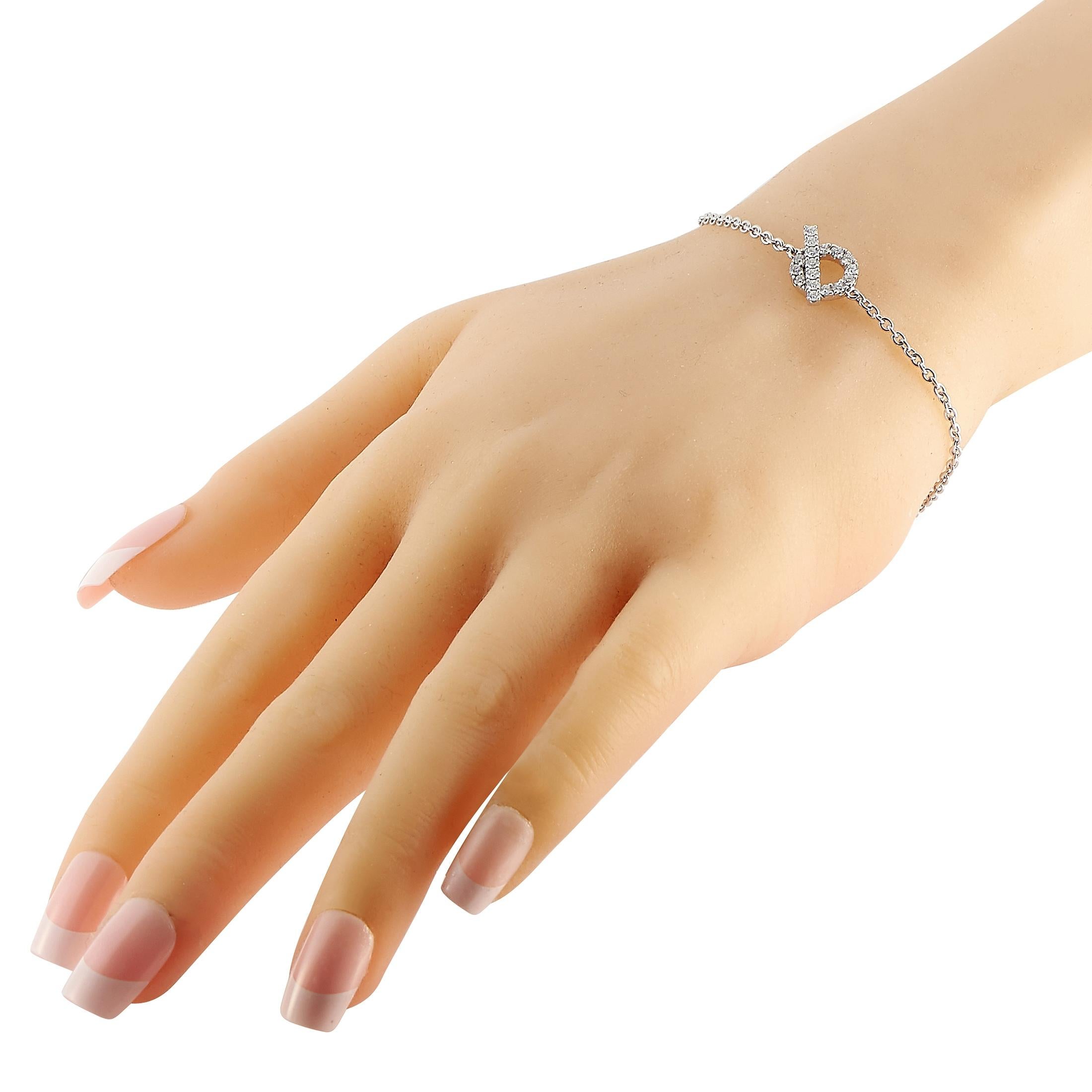 A delicate, understated sense of style is the hallmark of this impeccably crafted Hermès Finesse bracelet. Crafted from 18K white gold, a circular toggle accent covered in 0.55 carats of sparkling diamonds sits at the center of this piece’s 7” long