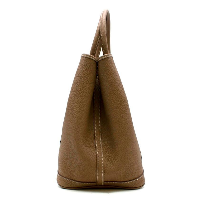 Hermes Garden Party 36 Bag in Etoupe

- Fjord Leather, Color: etoupe 
- Two rolled leather top handles
- Brown lacquered edges
- Internal zip pocket, chevron canvas lining
- Button closure 
- Additional bag insert inside 
- Negonda Calfskin