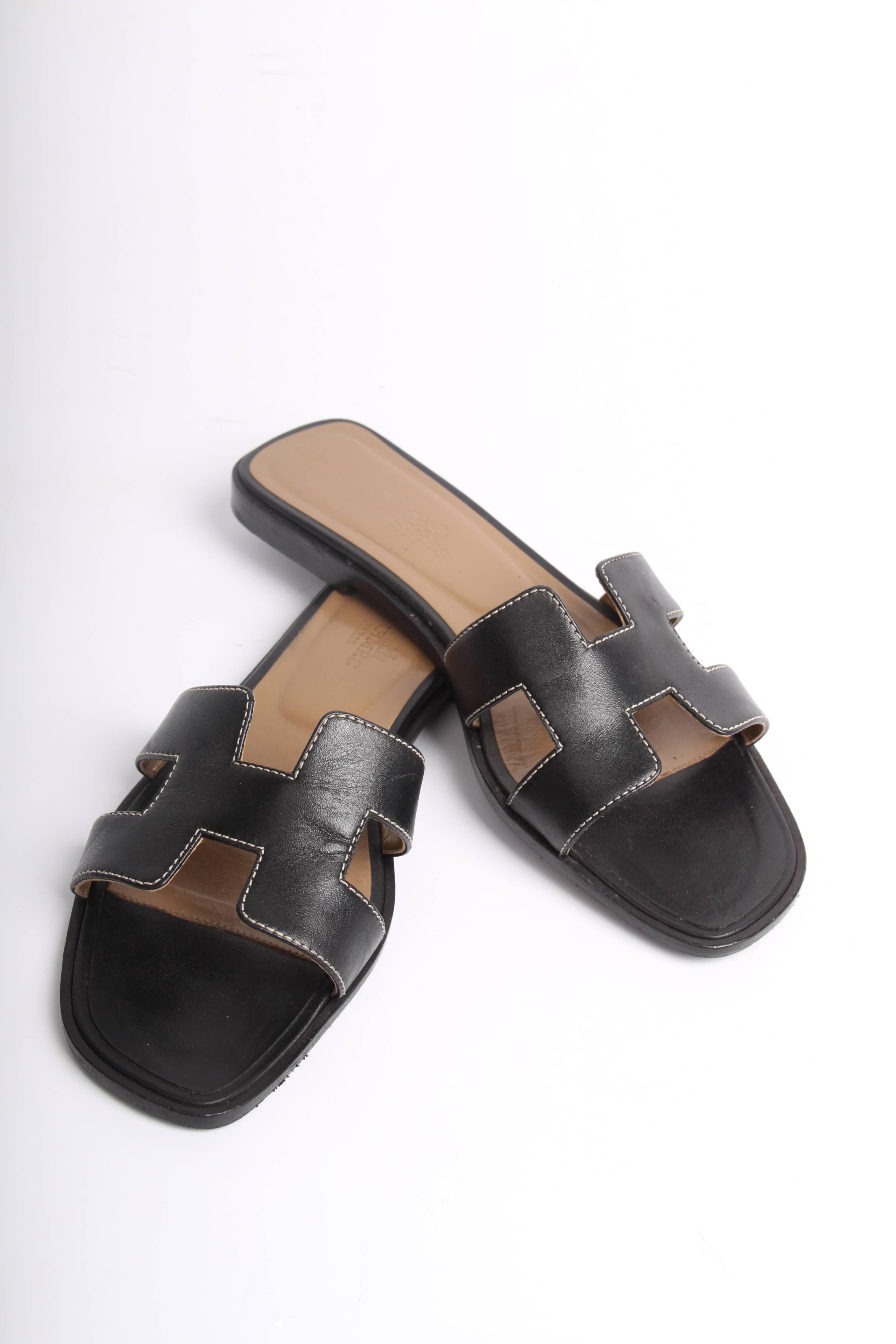 Flat sandals by Hermès with the welknown H on the instep.

These are crafted from black leather embellished with ecru stitching. The insole is taupe coloured and holds an Hermès logo. A black leather outsole. 

In superb condition, 9/10

Size: