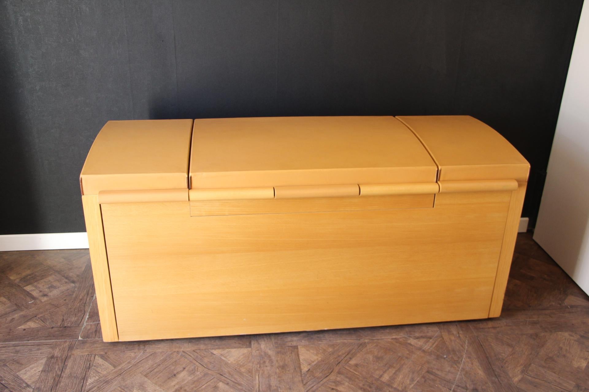 This spectacular shoe trunk was made by Hermes and John Lobb in 1990's. It is in beech wood and all the top section was upholstered by Hermes in natural cowhide Hermes leather. It features two leather side handles, a hinged top compartment with