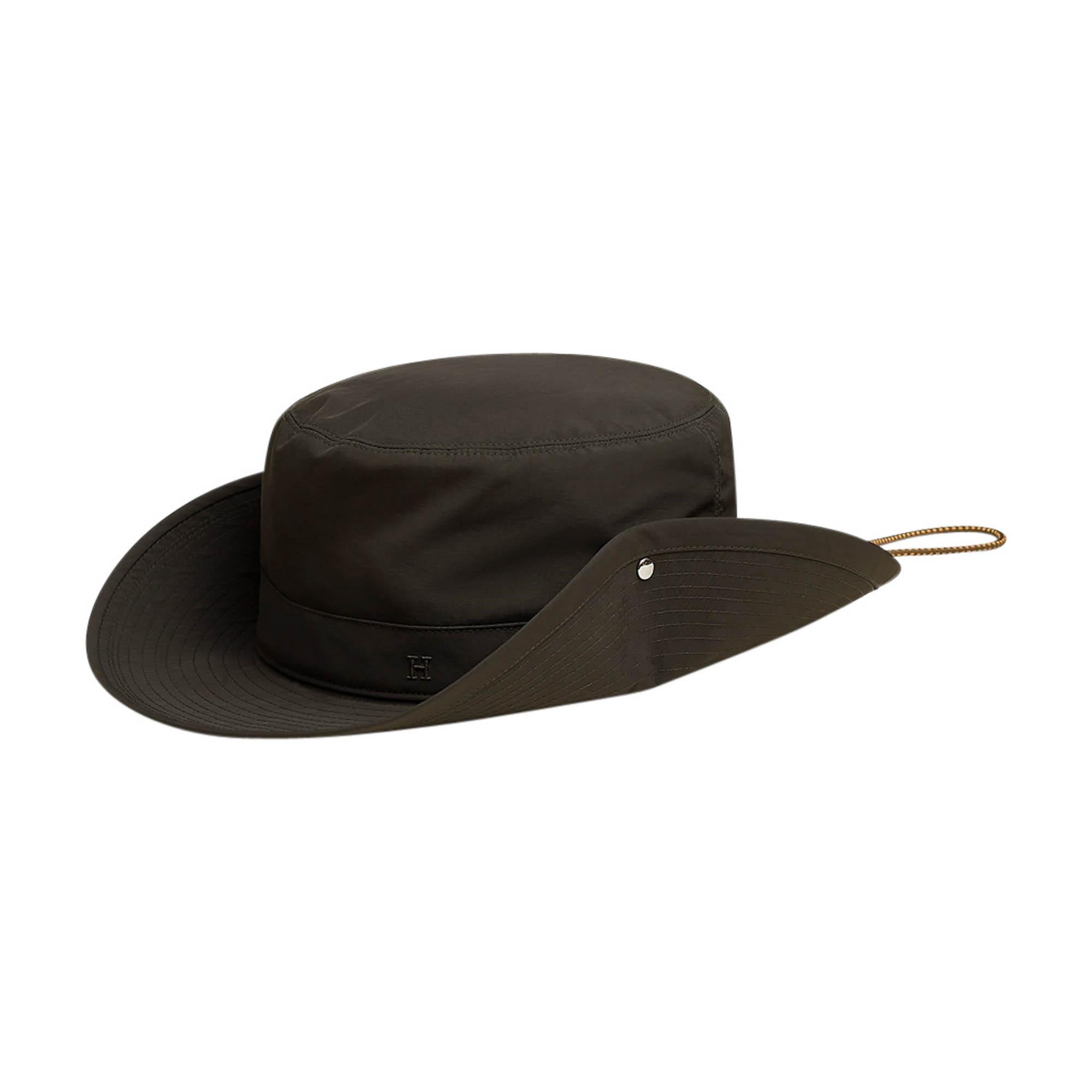 Mightychic offers an Hermes Forest Hat featured in Khaki Fonce plain Canvas.
Tone on tone H Droit embroidered on side.
Hat has brushed palladium plated Clou de Selle snaps on the sides to lift the 3