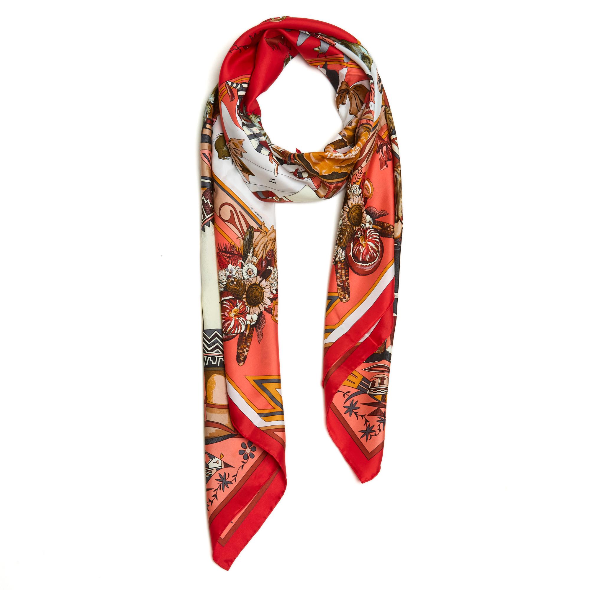 Hermès large square scarf 140 in silk twill titled Kachinas by Olivier Kermit, published in 1992 and reissued in 1997, 2004 (like this scarf) and 2012, in shades of red, ecru coral. Width 140 x length 140 cm approximately. The scarf is in very good