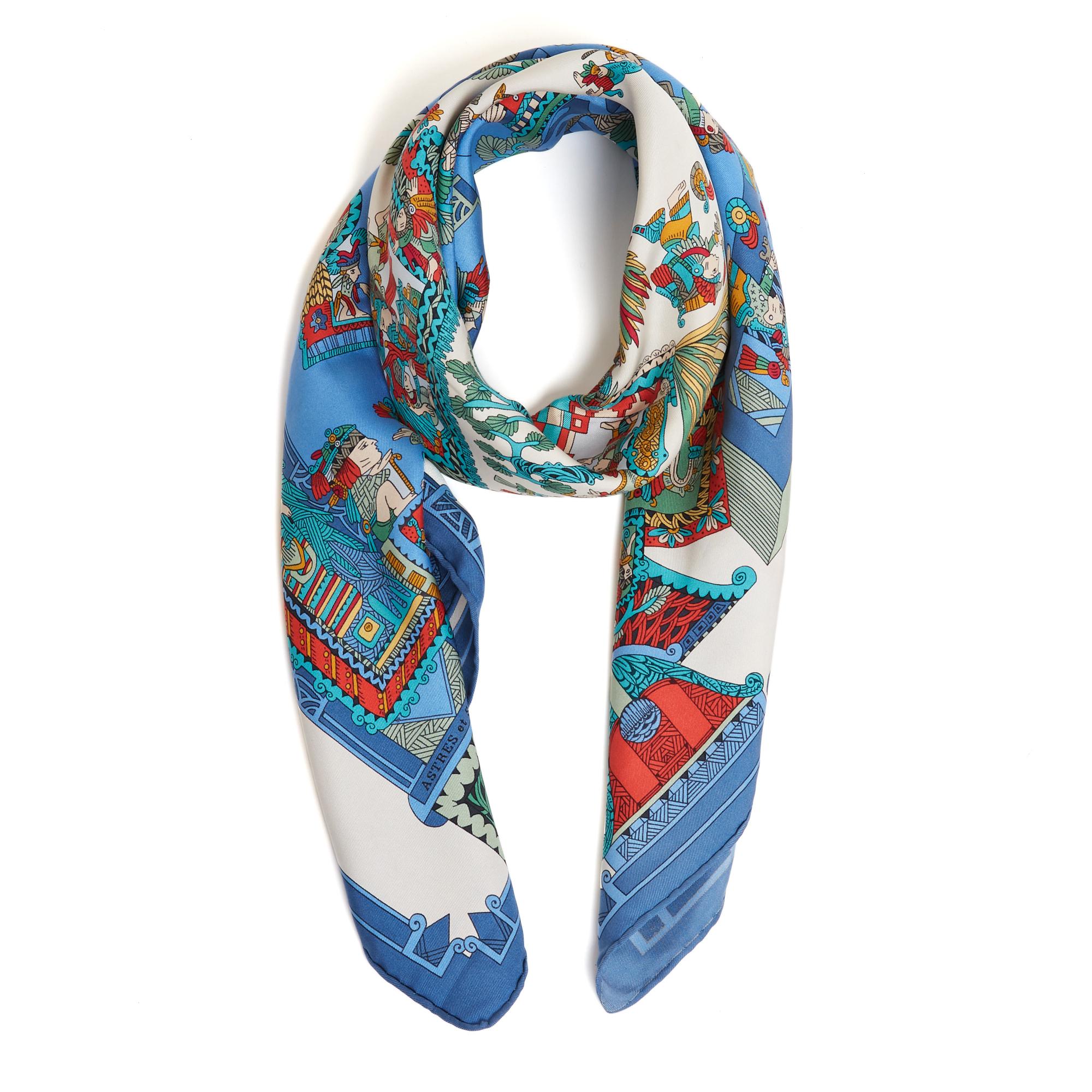 Hermès square scarf 90 in silk twill, Astres et Soleils pattern by Annick Faivre, produced once in 1994, in shades of blue. Width 90 cm x length 90 cm approximately. The square has been worn but it seems to be in very good condition, sought-after