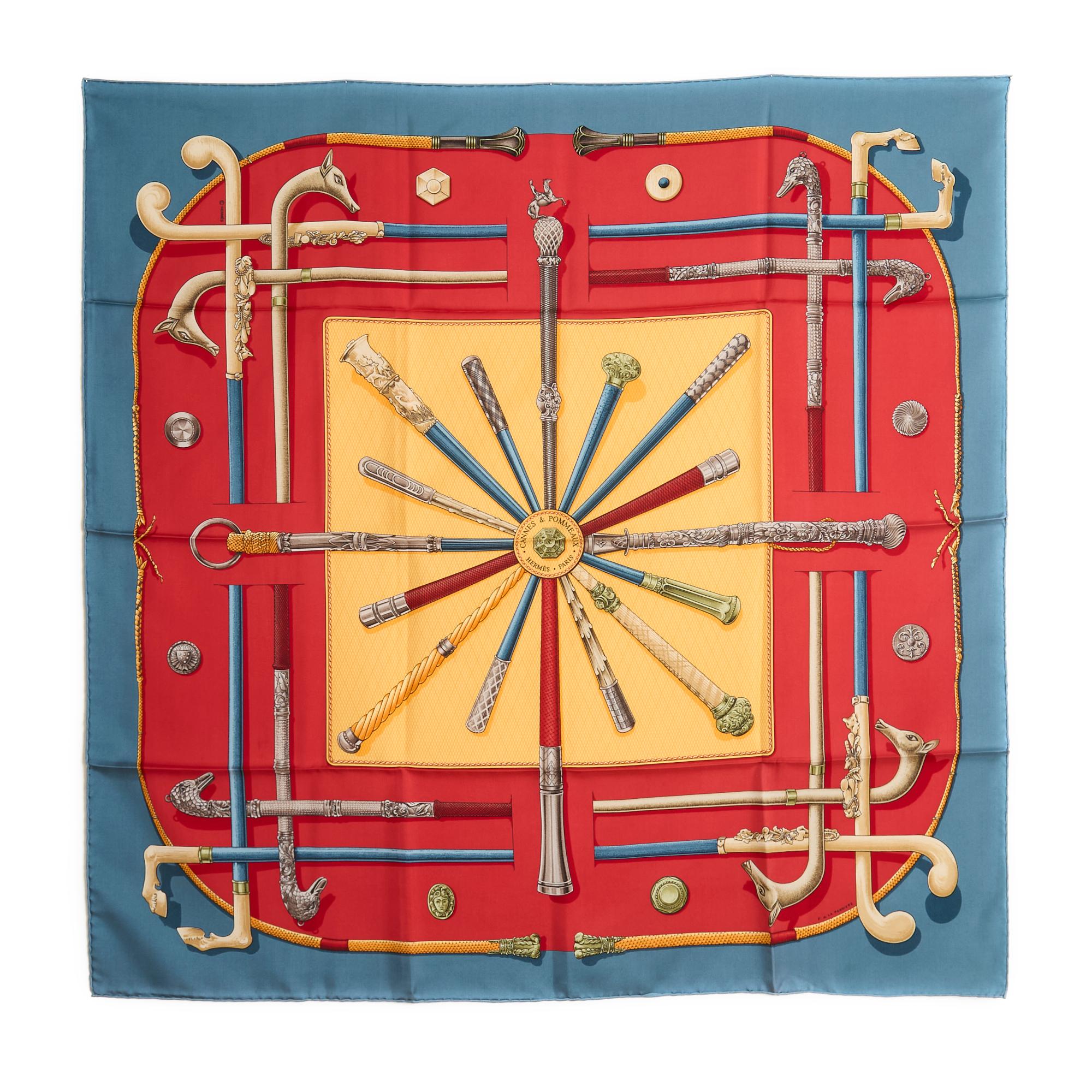 Hermès square 90 scarf in silk twill, Cannes and Pommeaux pattern by Françoise de la Perrière, published in 1985 and reissued in 1990 (like this one), patterns in pale yellow and red tones, gray blue edges. Width 90 cm x length 90 cm approximately.