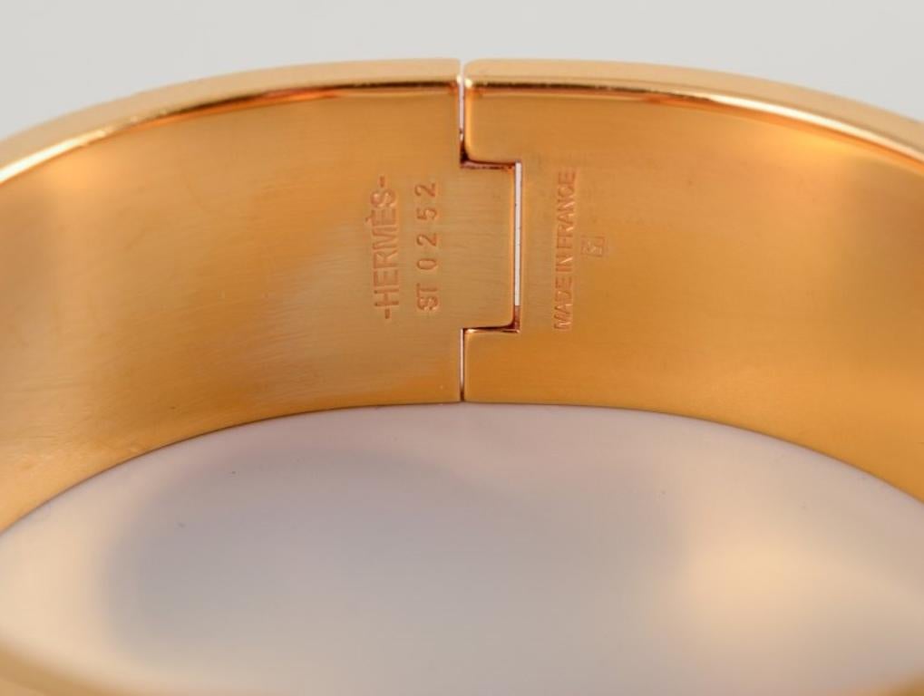 Women's Hermes, France. Clic Clac H bracelet. Gold-plated metal and enamel.