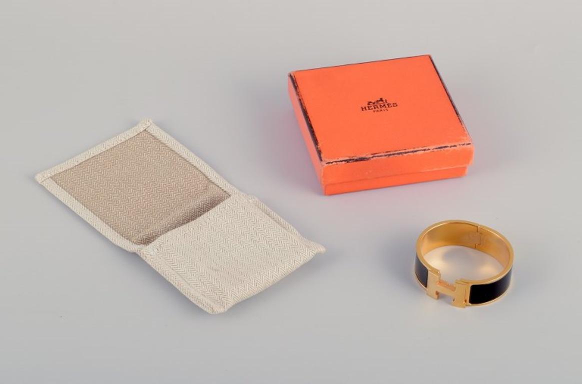 Hermes, France. Clic Clac H bracelet. Gold-plated metal and enamel. 1