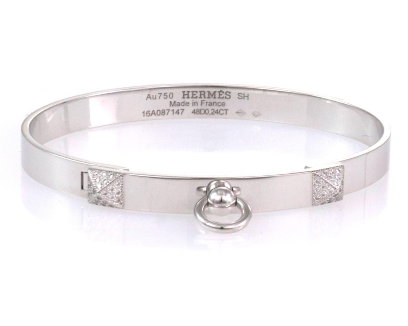This stunning Collier de Chein collection is by Hermes, it features an authentic bangle crafted from 18k white gold with a high polished finish featuring a 6mm wide band. The front of the bangle has two small pyramid like design set with diamond and