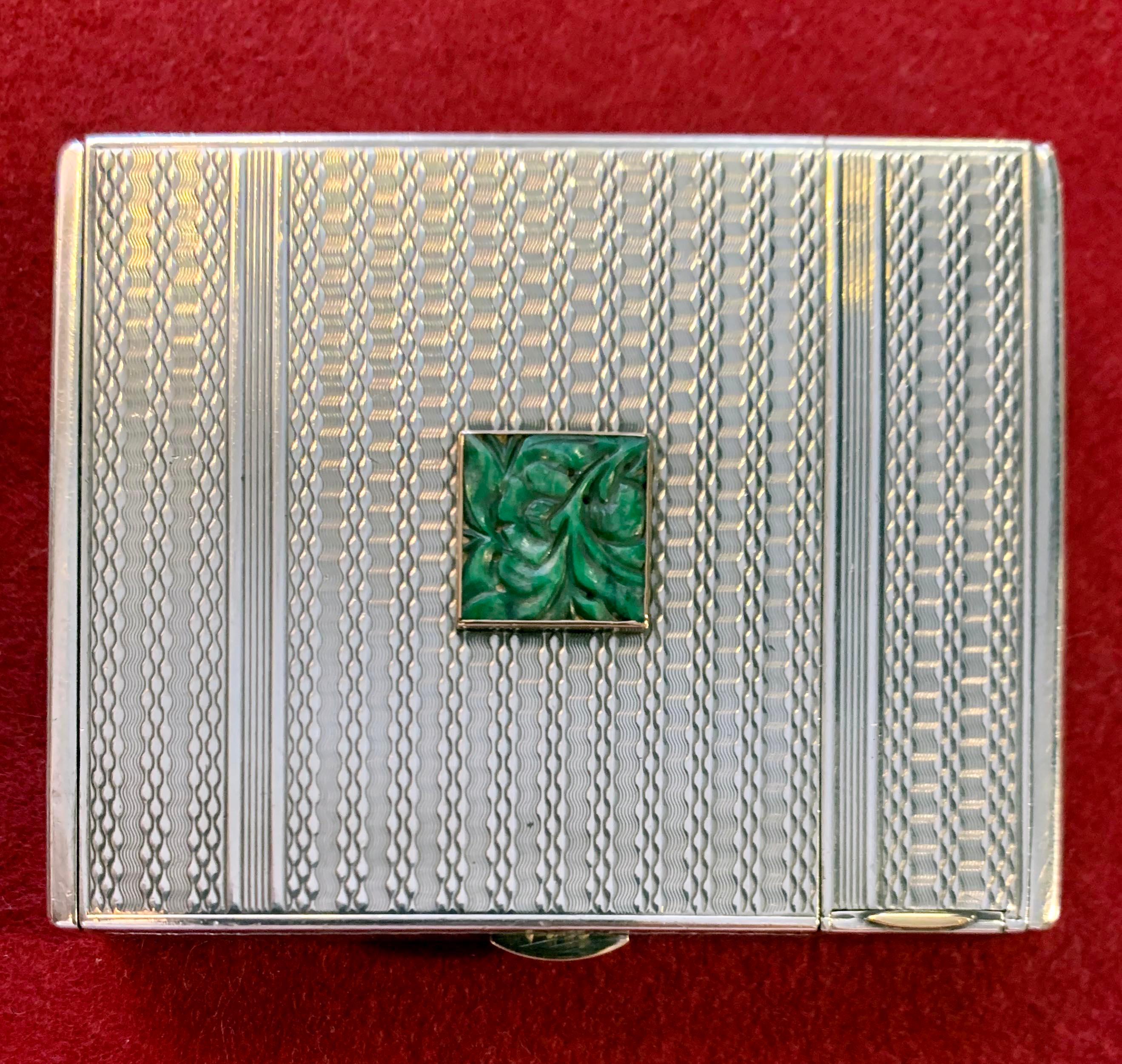 A circa 1940 French Art Deco .950 silver powder box with lipstick by Hermès. The powder box's parts are numbered 138. The box's bottom shows a serial number. The guilloché design on the silver body is decorated with a jade carved square and 18-karat