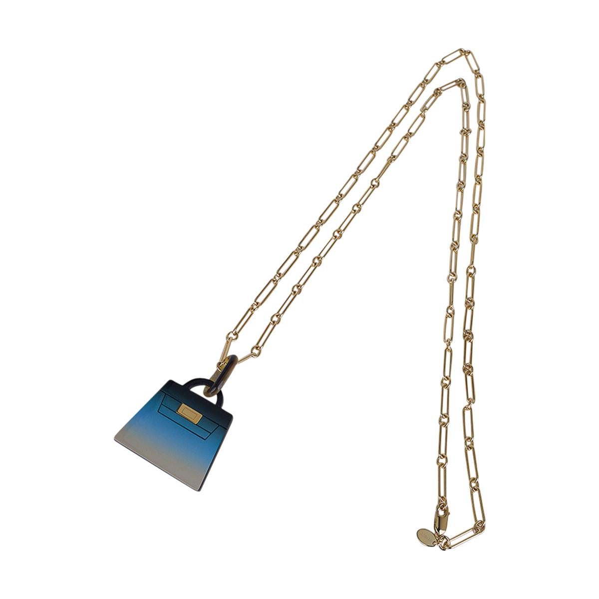 Mightychic offers an Hermes Fusion Kelly Pendant necklace featured in By The Sea.
Beautifully lacquered in hues of blue to beach sand.
This special lacquer technique is accentuated with a Permabrass chain link necklace.
Beautiful and unmistakably