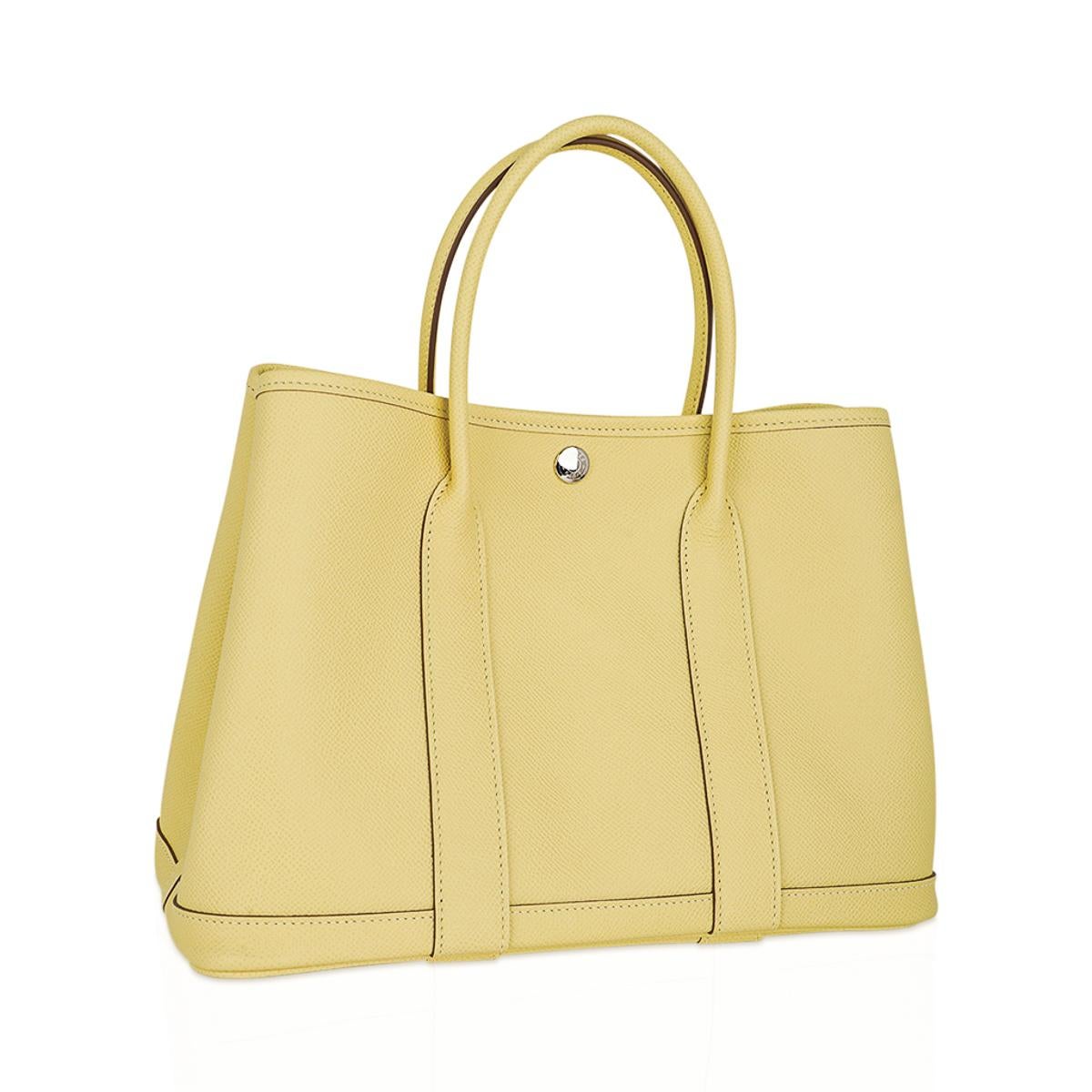 Mightychic offers an Hermes Garden Party 30 bag featured in coveted Jaune Poussin.
This sleek, simple clean lined Hermes tote bag is the perfect about town tote.
This gorgeous soft yellow bag is in Epsom leather.
Accentuated with palladium Clou de