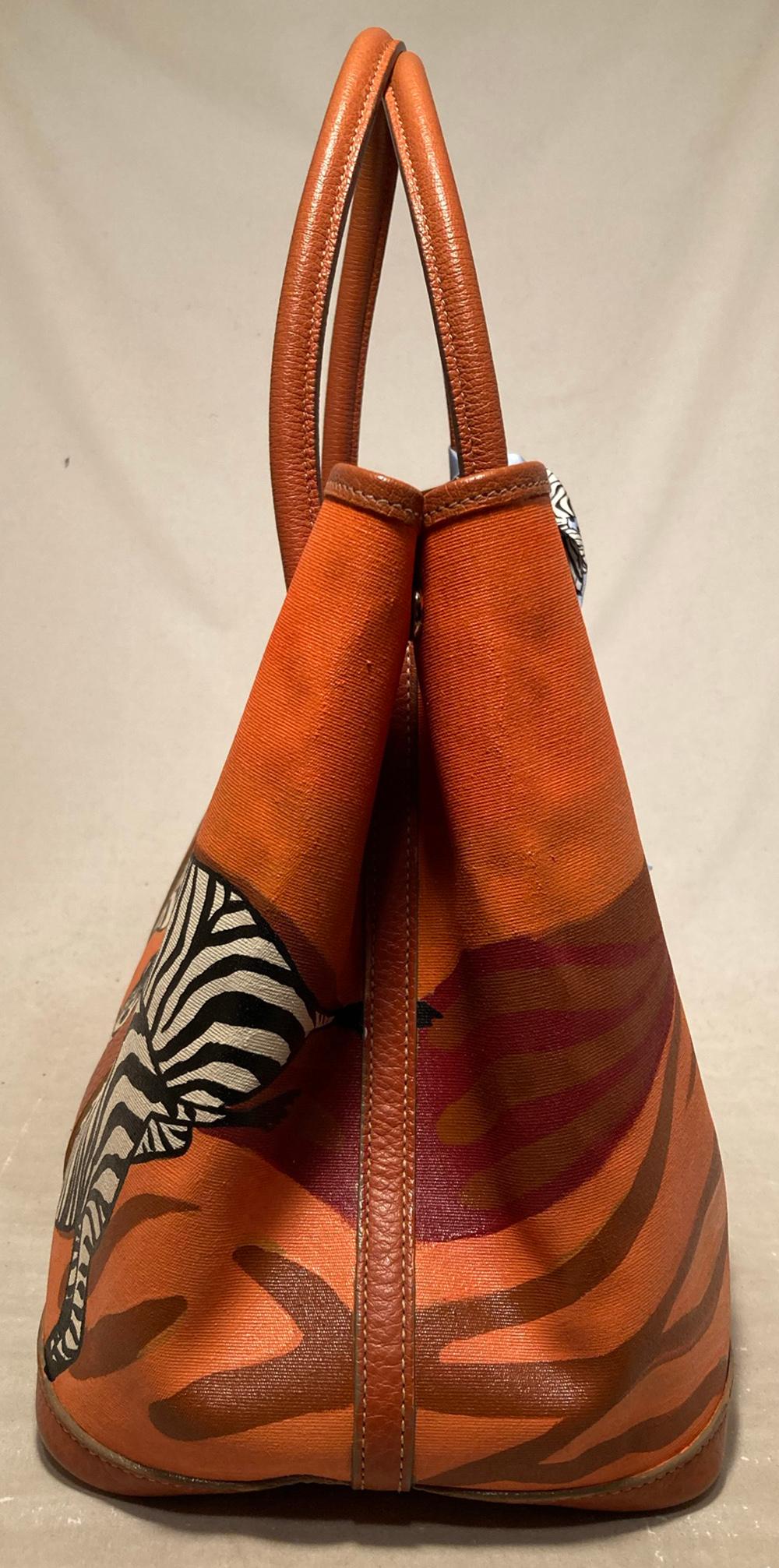 Hermes Garden Party 35 Hand Painted Zebra Print Tote in very good condition. Orange canvas exterior trimmed with orange leather and topstitching. One of a kind, hand painted zebra print painted on exterior canvas. Top snap closure opens to an
