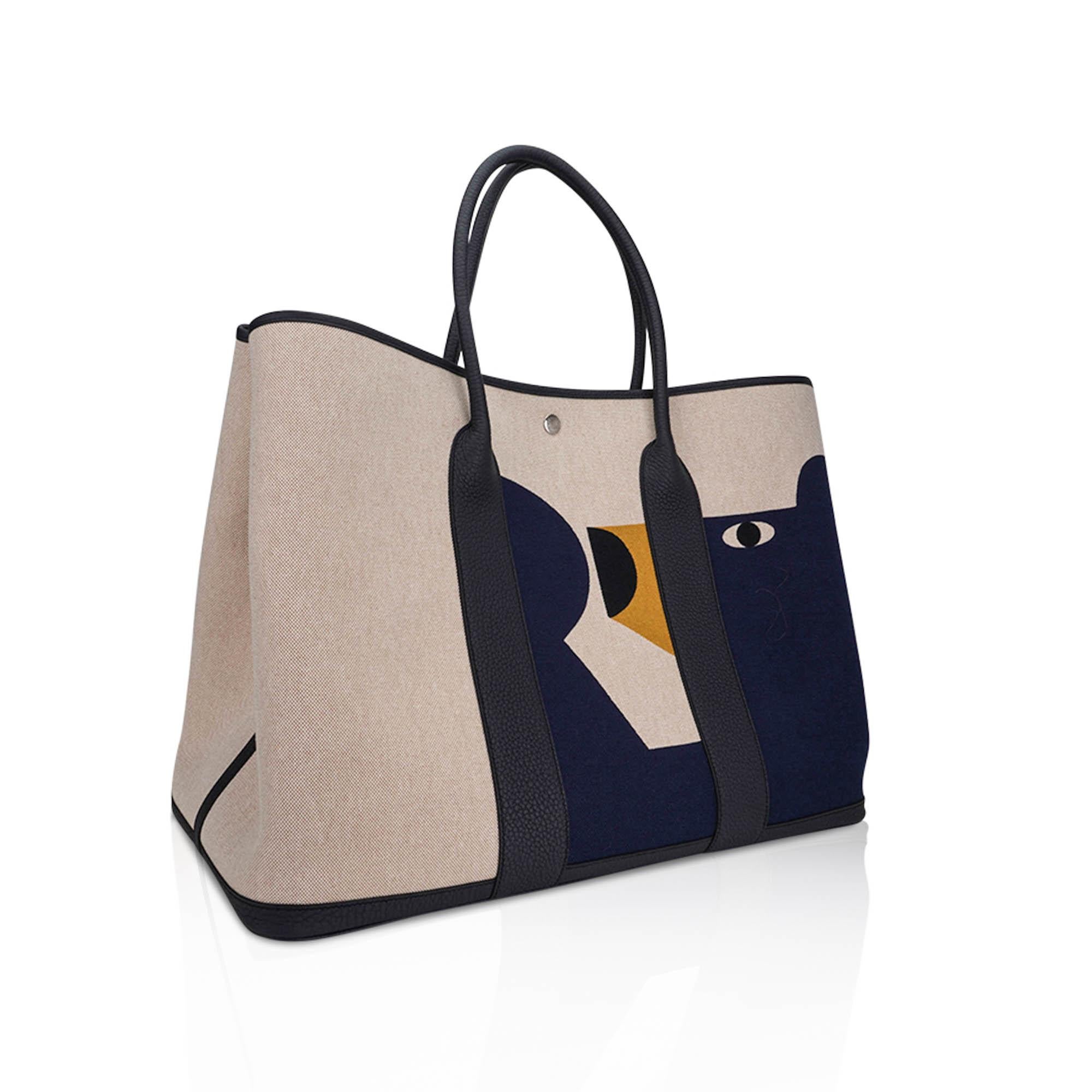 Mightychic offers an Hermes Garden Party 49 Voyage bag featured in Ecru, Beige, multicolore Indigo.
H Plume canvas in Ecru with an adventurous Teddy H motif in Navy.
Negonda calfskin in rich Blue Indigo.
Fresh palladium Clou de Selle snap