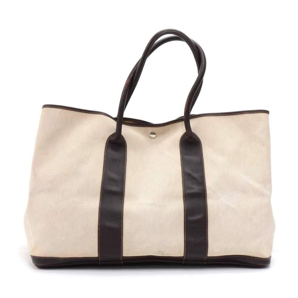 Hermes canvas and leather Garden Party Bag. Famous bag secured with silver tone stud in the middle and there are stud on each side as well. This is the largest size of the garden party bag. It can be comfortably carried on the shoulder. SKU: