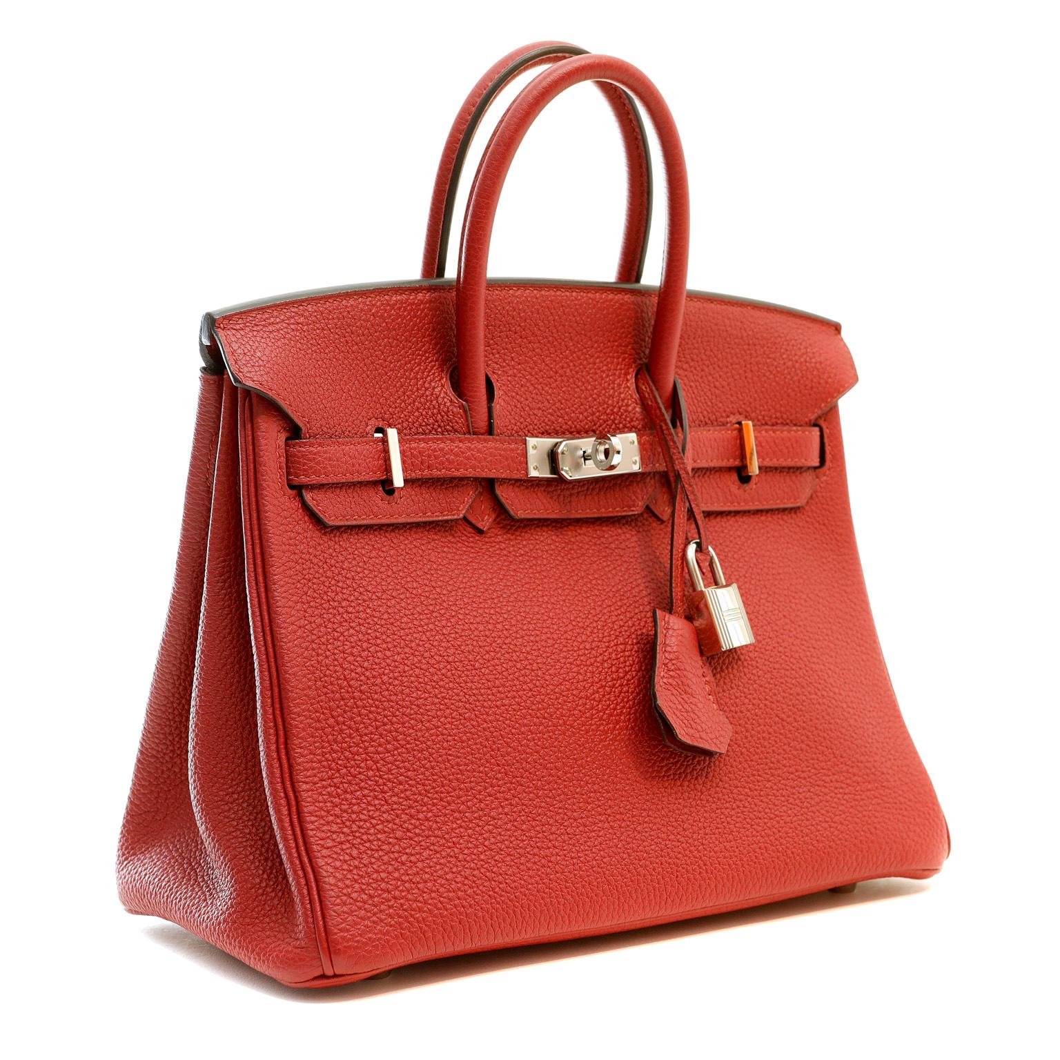 This authentic Hermès Garnet Red Togo Leather 25 cm Birkin is in pristine unworn condition with the protective plastic on the hardware.  A rich dark red, this jewel tone is perfectly paired with palladium hardware.

Togo is scratch resistant calf