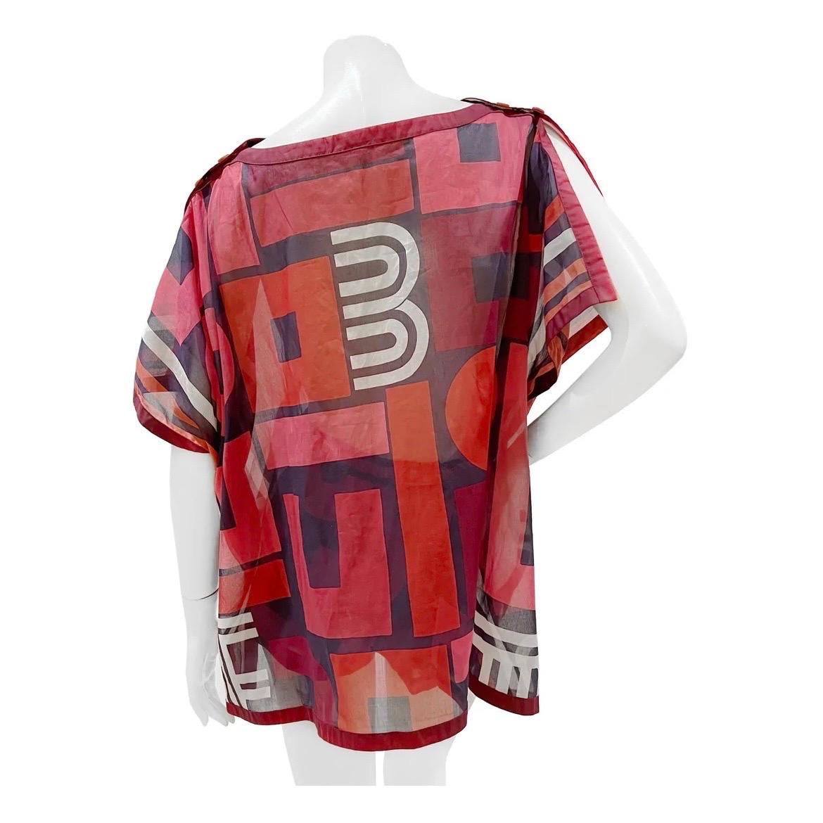 Geometric Print Sheer Poncho and Shorts Set by Hermes 
Made in France
Navy, purple, red and white geometric print 
Sheer and light fabric
Square style poncho
Poncho has dual top button closure on shoulders 
Dual button closure for arms 
Pearl